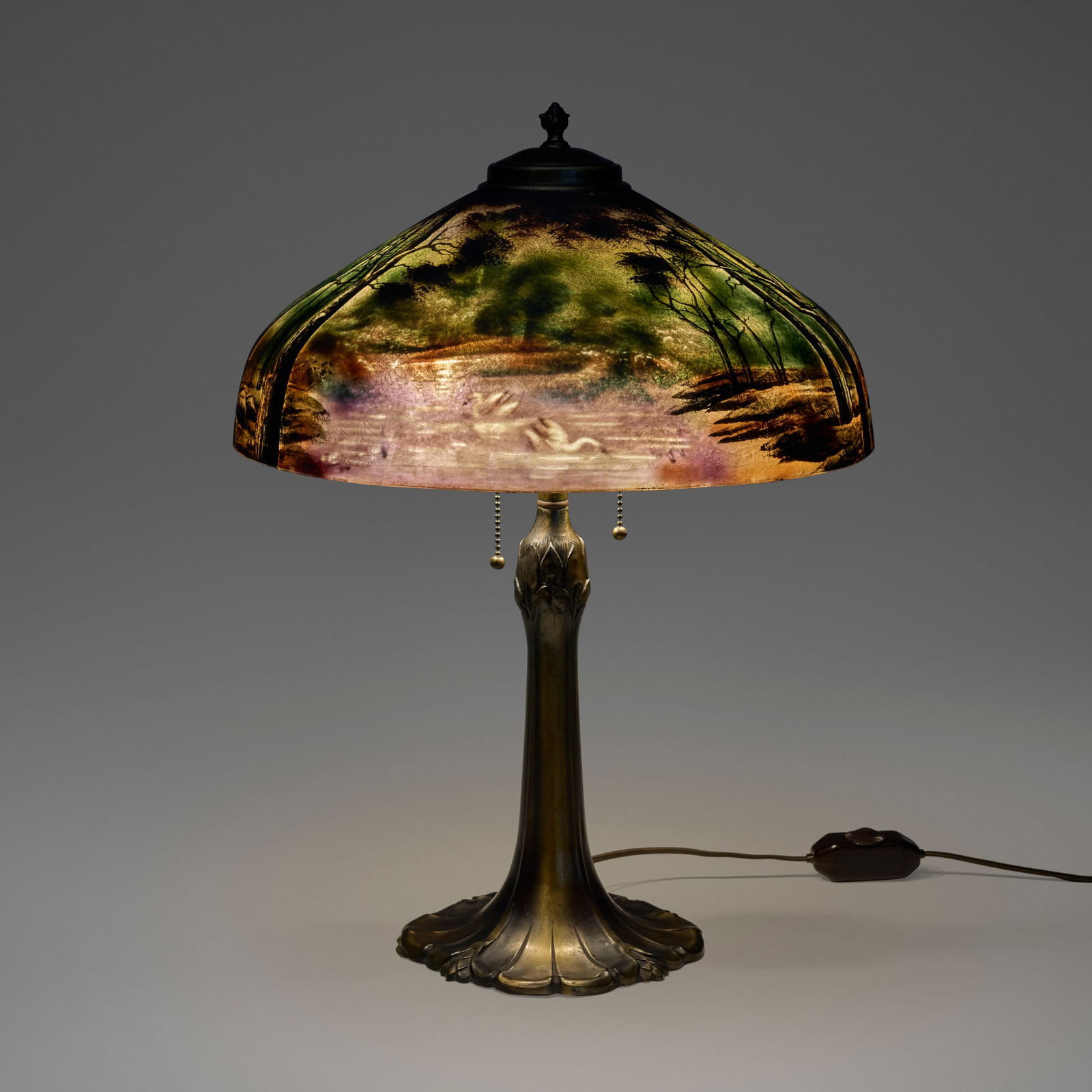 Pittsburgh Lamp, Brass & Glass Company, Table lamp with swans, pond and woods: Pittsburgh Lamp, Brass & Glass Company Table lamp with swans, pond and woods USA, c. 1920acid-etched and reverse-painted glass, patinated metal 22 h x 15.75 dia in (56 x 40 cm) Paper manufactu