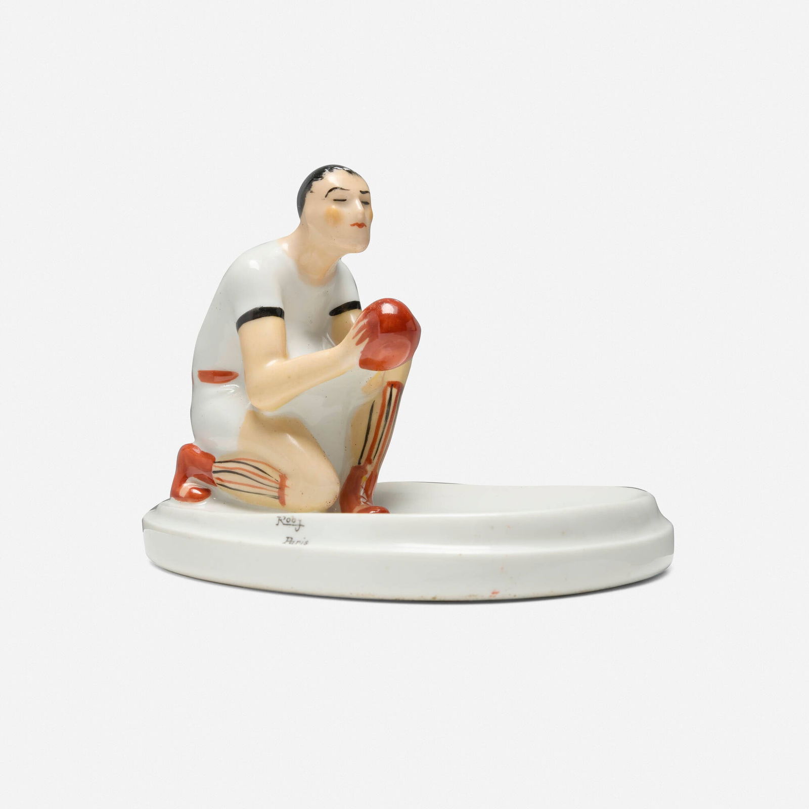 Robj, Ashtray with rugby player: Robj Ashtray with rugby player France, c. 1930glazed porcelain 4 h x 6 w x 4.25 d in (10 x 15 x 11 cm) Stamped manufacturer's mark to edge 'Robj Paris'. Paper distributor's label to underside