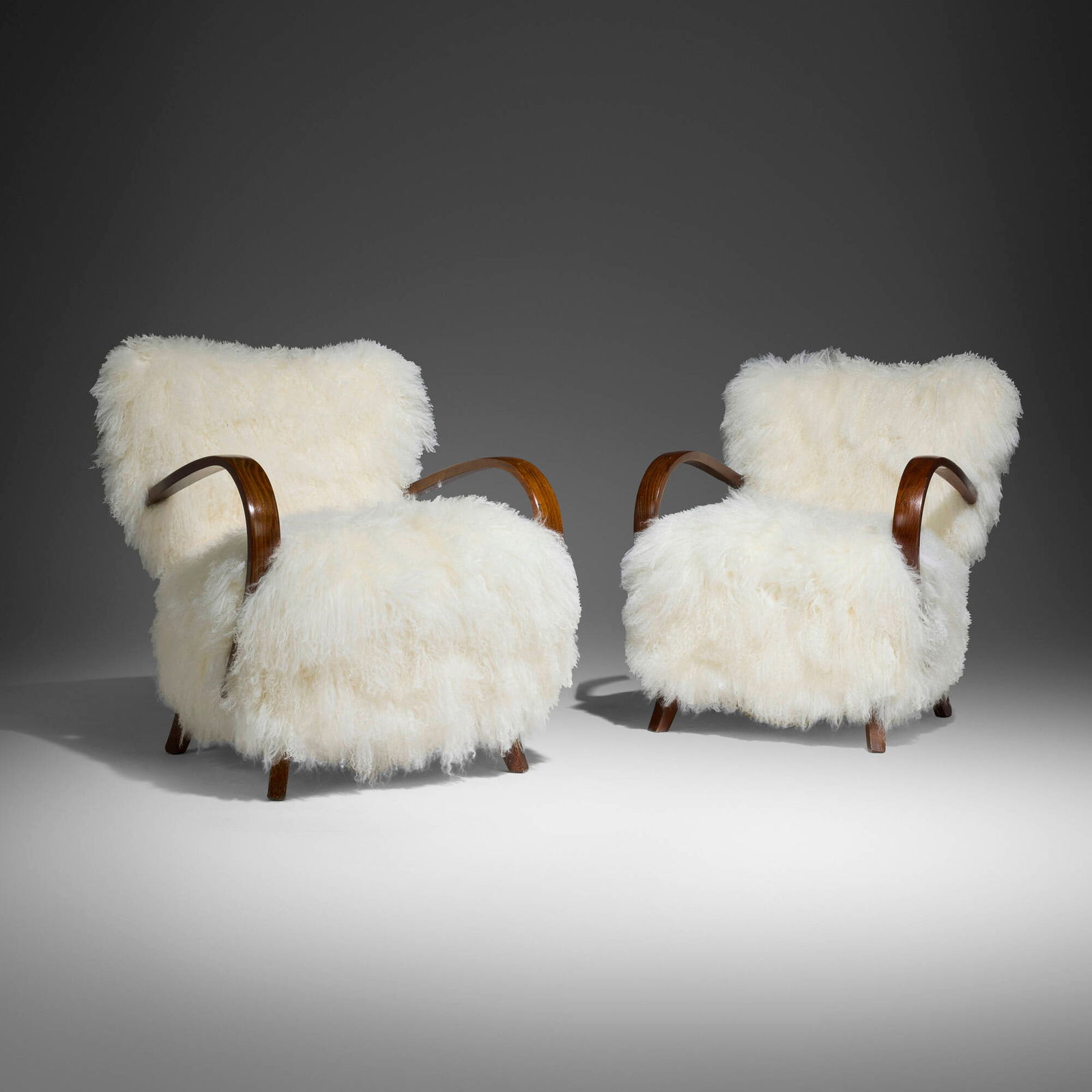 Swedish, Lounge chairs, pair: Swedish Lounge chairs, pair c. 1960sheepskin, stained beech 30 h x 26 w x 34 d in (76 x 66 x 86 cm) This work will ship from Chicago, Illinois.
