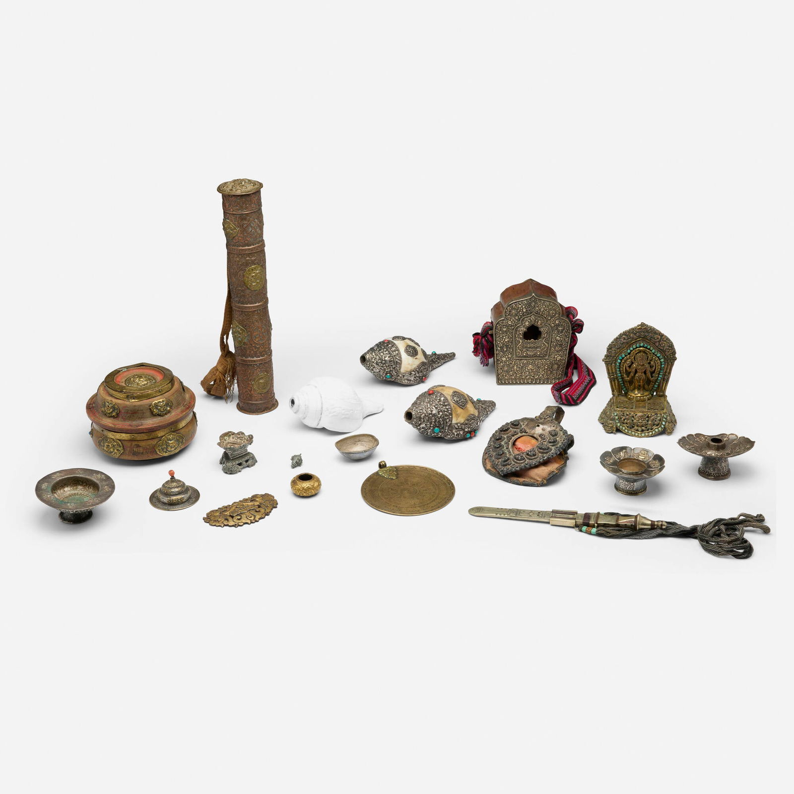 Tibetan and Mongolian, Collection of eighteen artifacts: Tibetan and Mongolian Collection of eighteen artifacts late 19th-20th centuryrepousse and hand-chased mixed metals, copper, silver gilt, shell, painted wood, fabric, leather, woven fabric, turquoise,