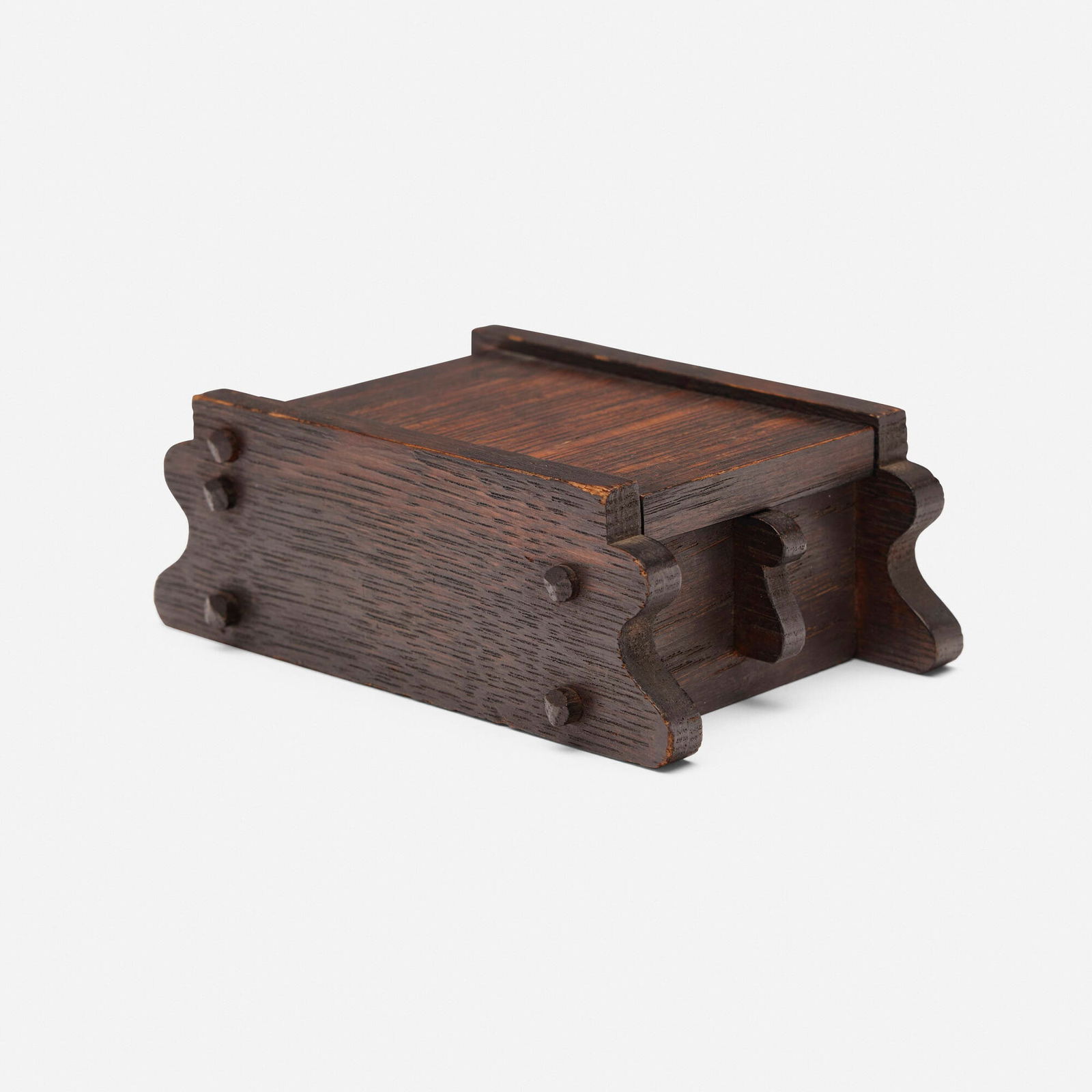 Charles Rohlfs, Stamp box: Charles Rohlfs Stamp box USA, 1901 oak 2 h x 5.5 w x 3.5 d in (5 x 14 x 9 cm) Carved and red wax-filled signature and date 'R 1901' with saw cipher. This work will ship from Chicago, Illinois.