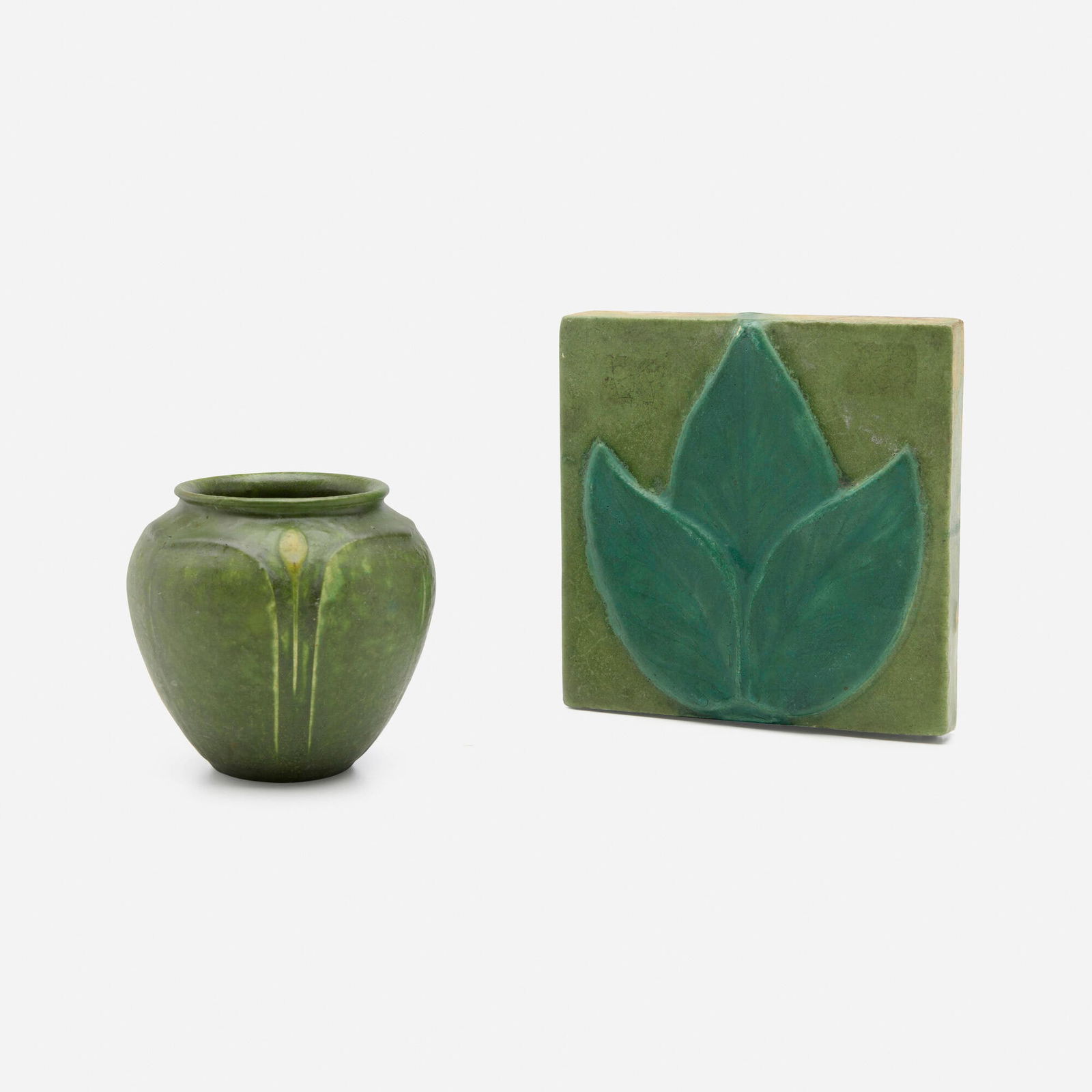 Grueby Faience Company, Vase and tile: Grueby Faience Company Vase and tile USA, 1899-1910 glazed earthenware 6 h x 6 w x 0.75 d in (15 x 15 x 2 cm) 4.25 h x 4 dia in (11 x 10 cm) Vase features leaves and buds, and tile features