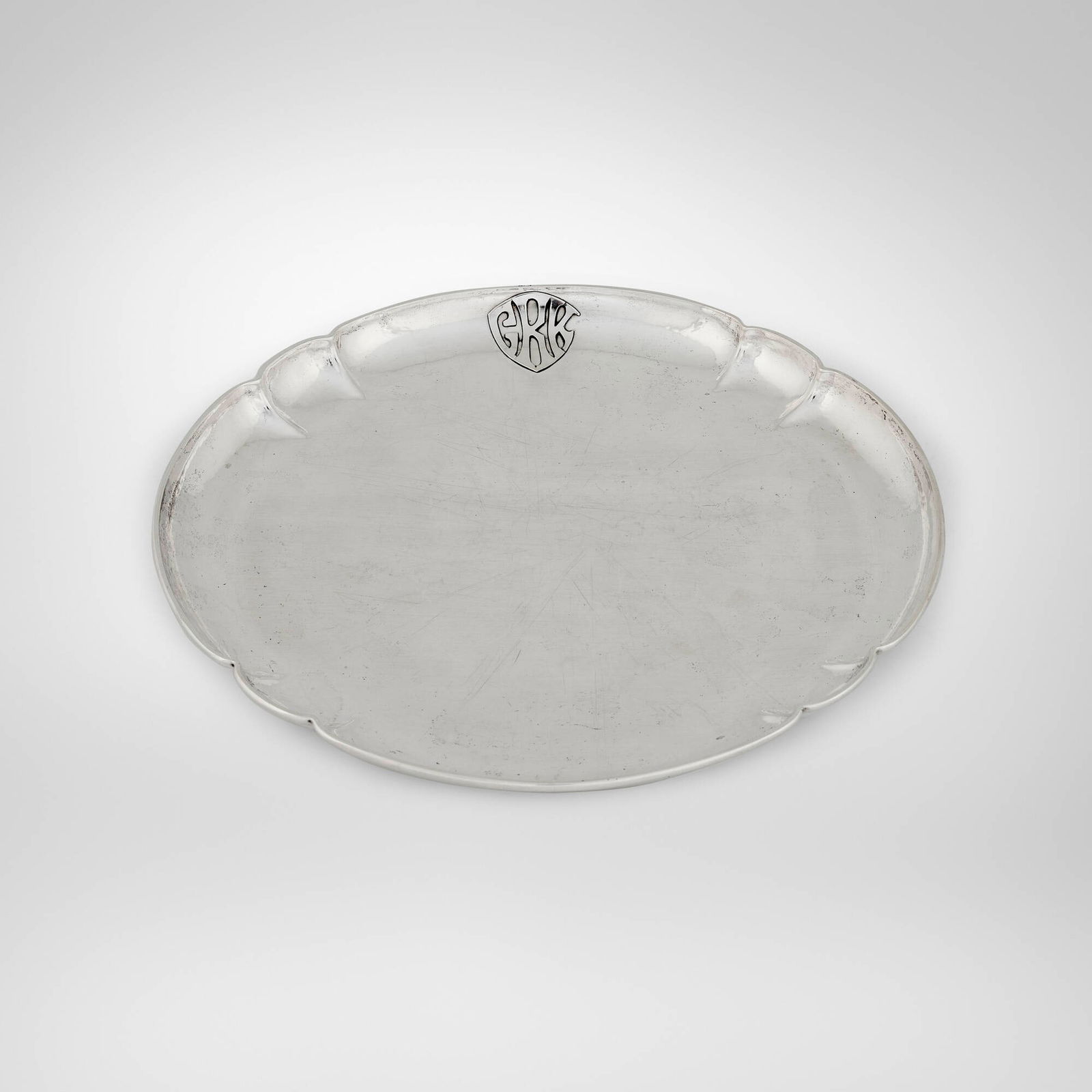 Falick Novick, Round tray with lobed accents: Falick Novick Round tray with lobed accents Chicago, USA, c. 1910 sterling silver 0.875 h x 11.875 dia in (2 x 30 cm) Impressed signature to underside 'Sterling Handwrought F. Novick Chicago'.