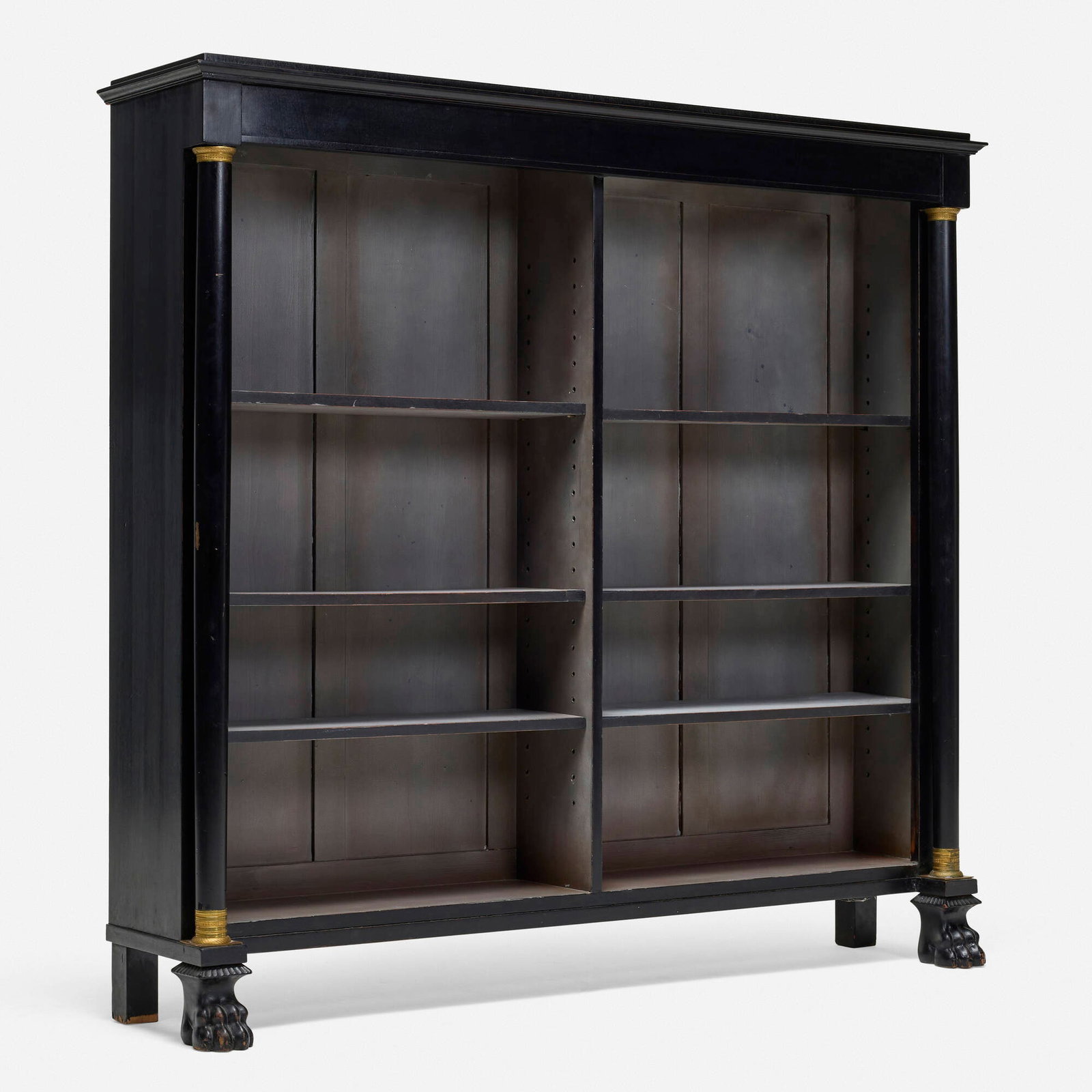 Empire Style, Bookcase: Empire Style Bookcase 20th century ebonized wood, gilt metal 61.5 h x 65 w x 15 d in (156 x 165 x 38 cm) Bookcase features six adjustable shelves and two paw feet. Provenance: Collection of
