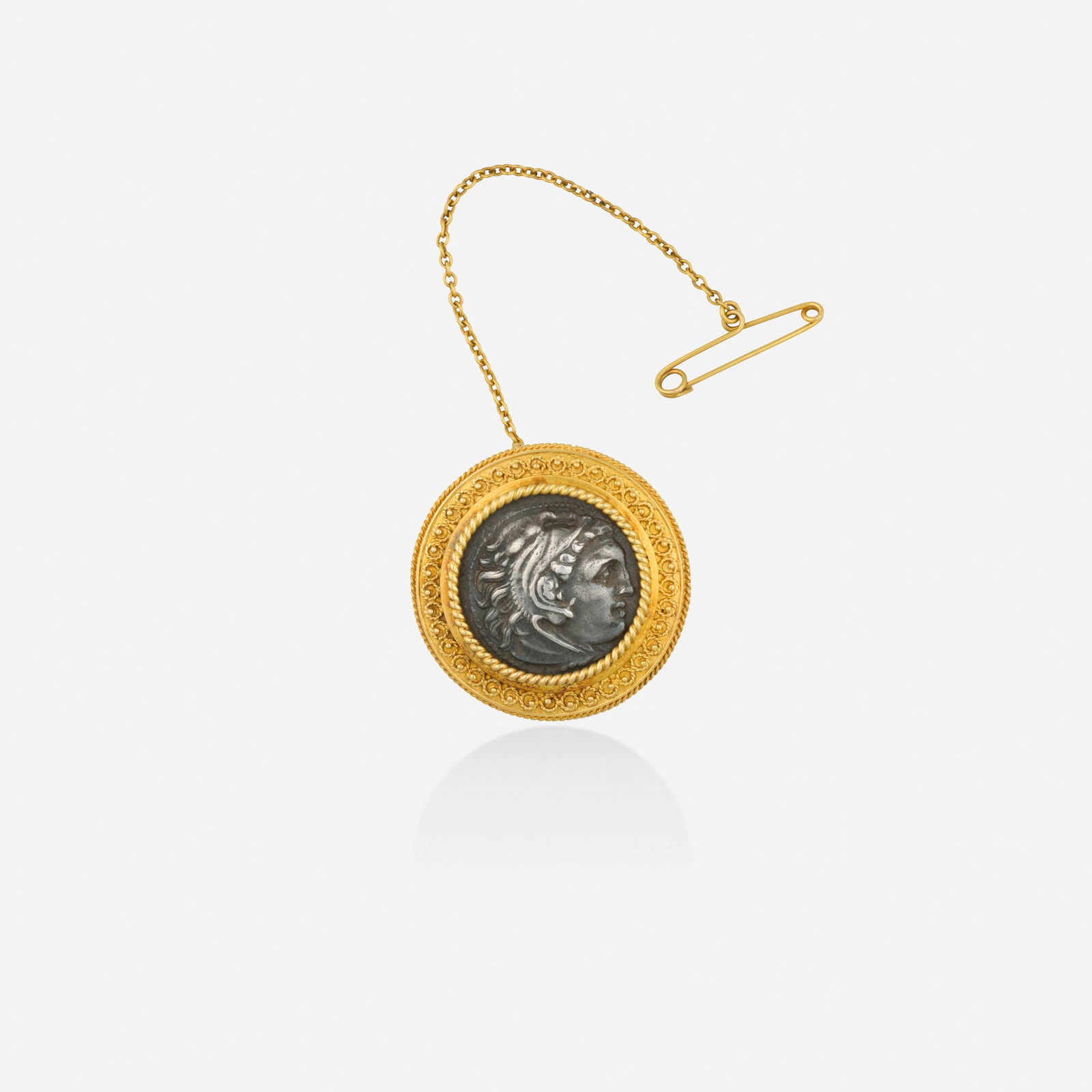Grand Tour, Coin and gold brooch: Grand Tour Coin and gold brooch Set with a silver tetradrachm coin, framed by gold granulation and wirework Yellow gold 1 in; Gross weight 6.2 dwts This work will ship from Lambertvil