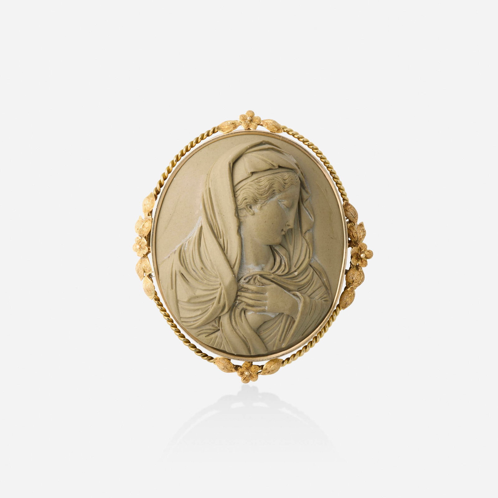 Victorian, Lava cameo and gold brooch: Victorian Lava cameo and gold brooch Set with a lava cameo depicting the Virgin Mary, with a floral and roped gold frame Yellow gold 2.25 x 2 in; Gross weight 23.2 dwts This work will