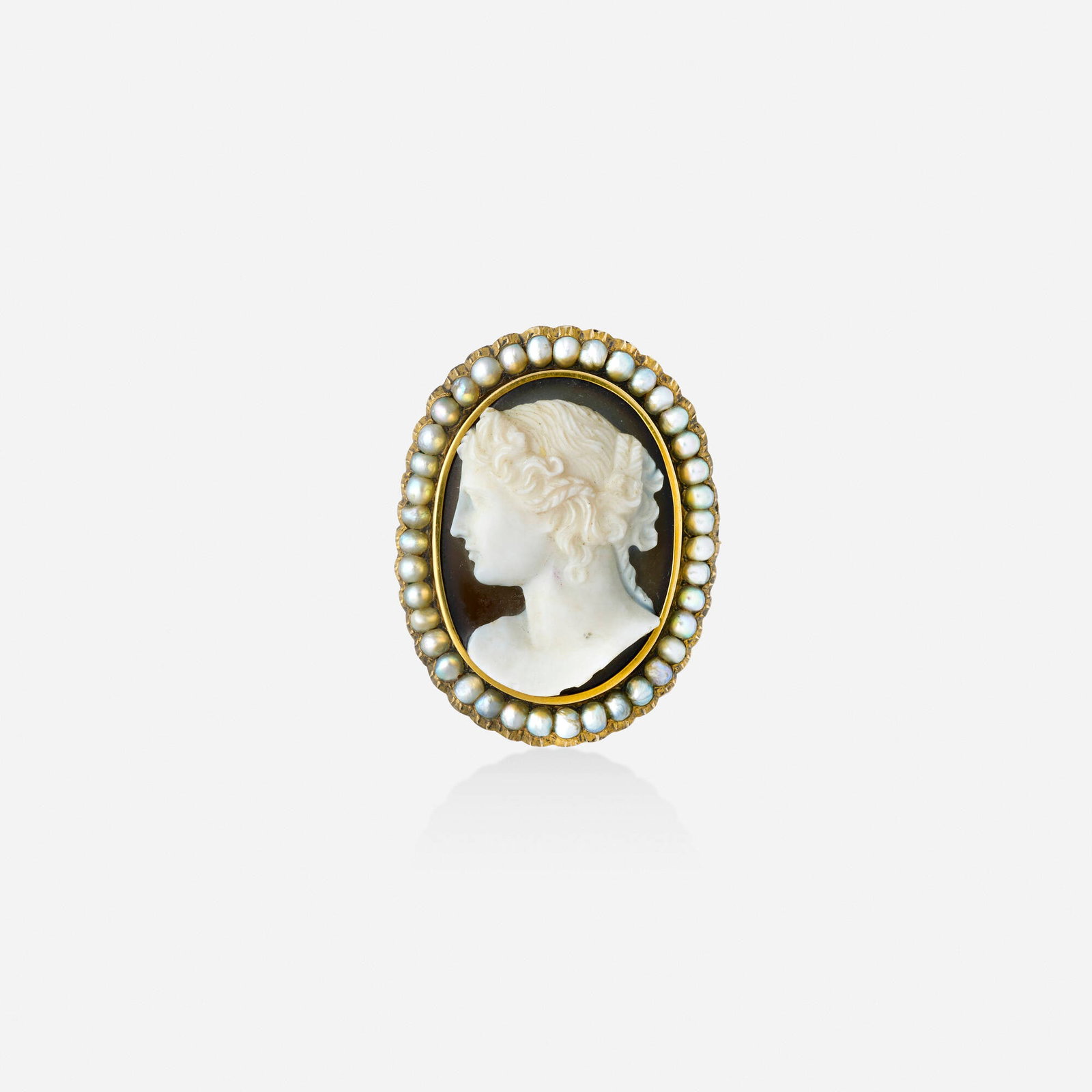 Victorian, Cameo, seed pearl, and gold brooch: Victorian Cameo, seed pearl, and gold brooch Set with a carved agate cameo framed by seed pearls Yellow gold 1.625 x 1.25 in; Gross weight 11.5 dwts This work will ship from Lambertvil