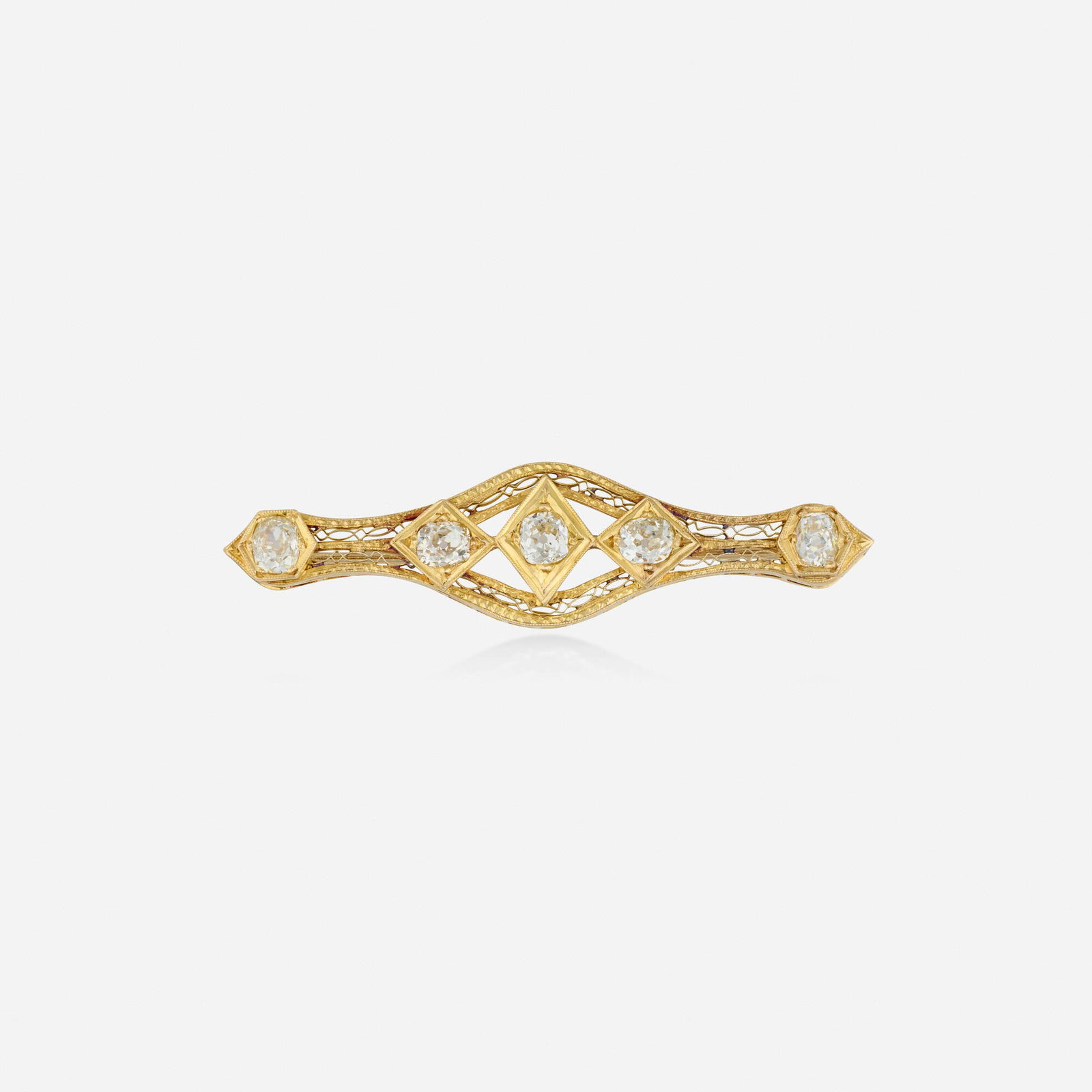 Antique, Diamond and gold brooch: Antique Diamond and gold brooch Of open-form design, set with old mine-cut diamonds 14k yellow gold 2.25 x 0.50 in; Gross weight 3.2 dwts This work will ship from Lambertville, New Jer