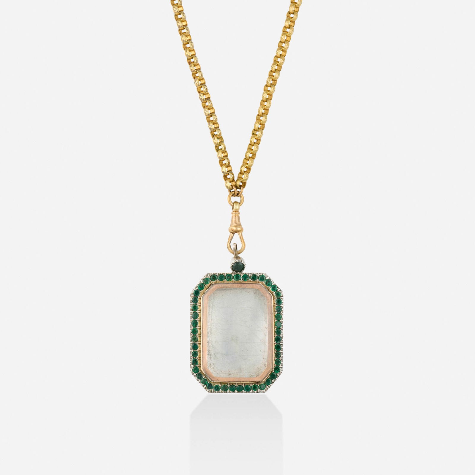 Antique, Emerald and silver gilt locket necklace: Antique Emerald and silver gilt locket necklace The locket set with circular-cut emeralds, suspended from the long chain Silver, silver gilt, 14k yellow gold Necklace 32 in, locket 2 x 1.375 in; Gross