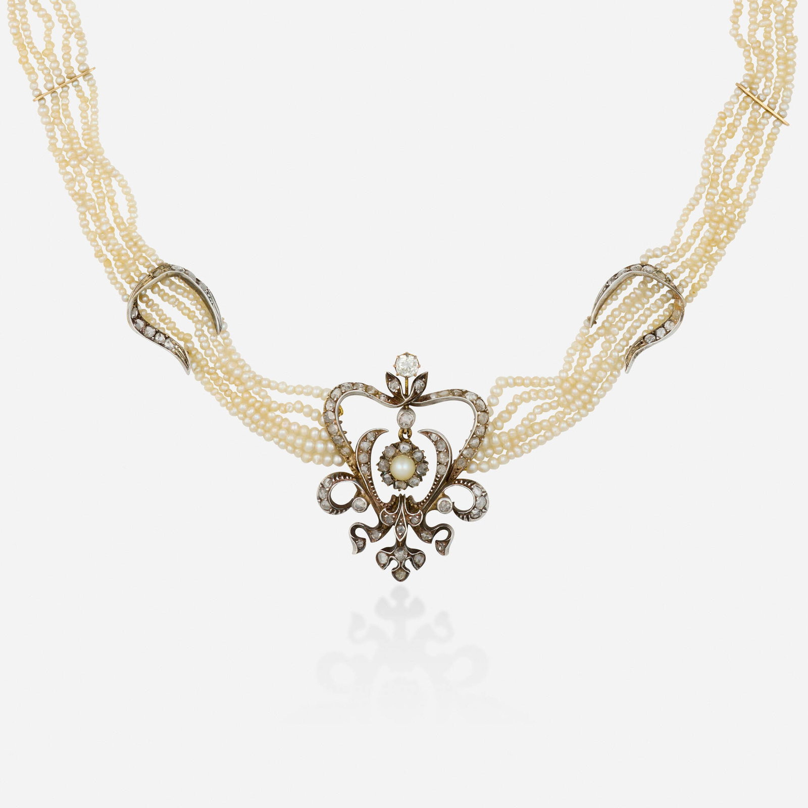 Antique, Diamond, pearl, gold, and silver necklace: Antique Diamond, pearl, gold, and silver necklace Designed with five seed pearl stands and three pendants set with pearls, old mine and rose-cut diamonds Silver-topped yellow gold 16 in; Gross weight