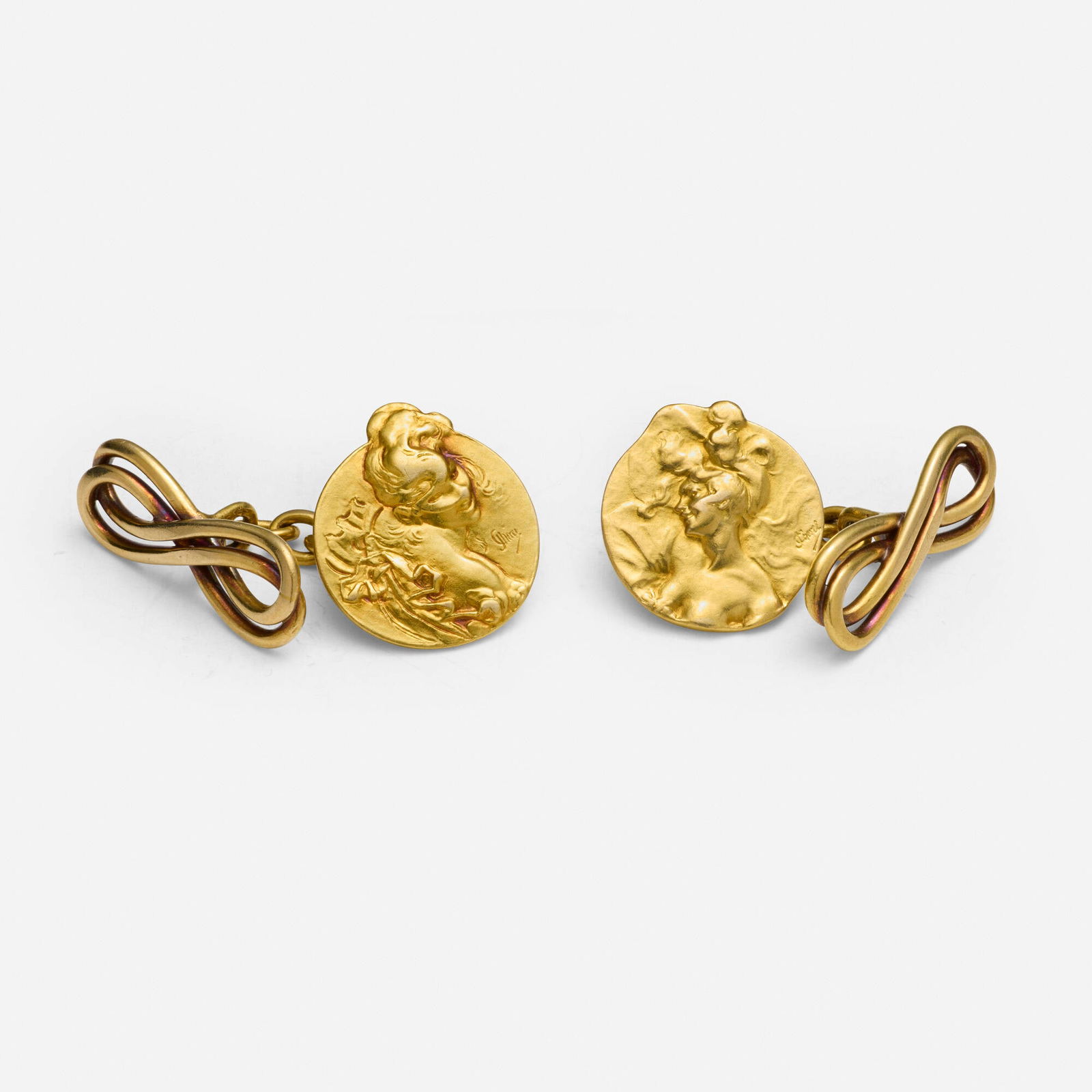 Jules Cheret, Art Nouveau gold cufflinks: Jules Cheret Art Nouveau gold cufflinks Each depicting a woman's profile, one wearing a mask based on Bal Masque; 1900s 18k yellow gold Signed J Cheret 0.75 x 0.50 in; Gross weight 5.4 dwts <