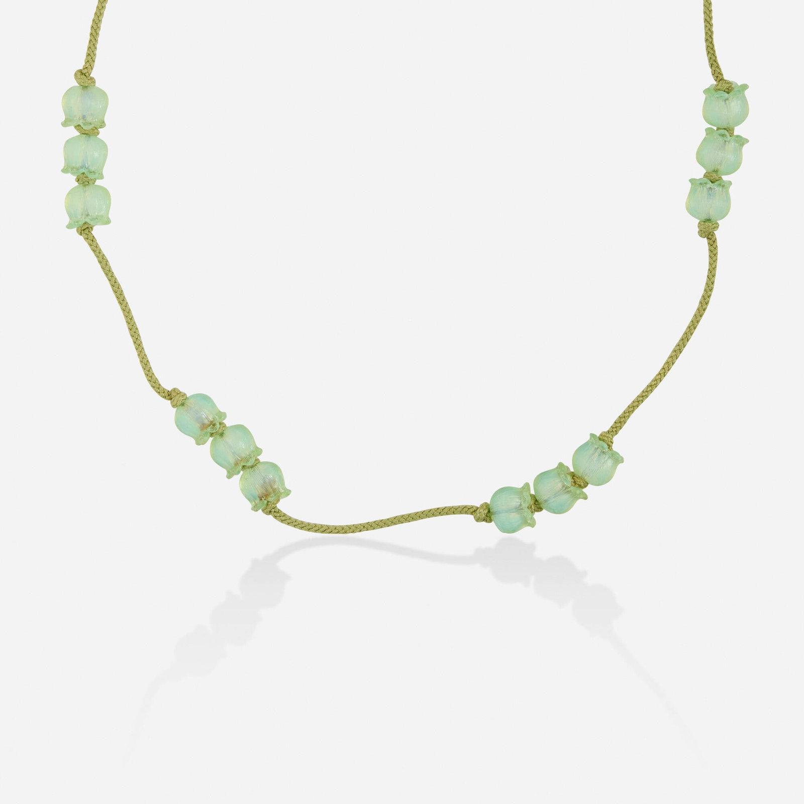 Rene Lalique, Art Nouveau 'Muguet' glass necklace: Rene Lalique Art Nouveau 'Muguet' glass necklace Designed with lily-of-the-valley-shaped glass beads and green cord, model no. 1509 Approx. 30 in; Gross weight 56.7 dwts Sold with extra beads