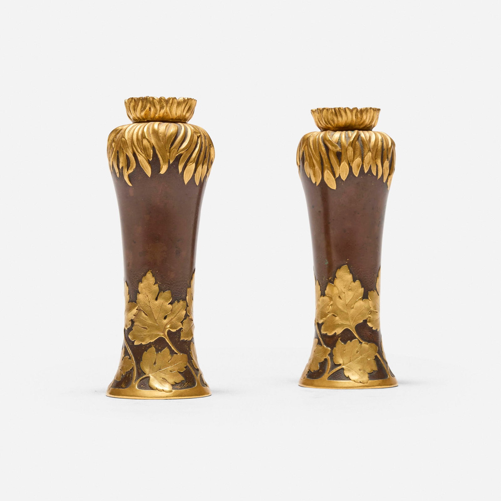 Christofle, Vases with leaves, pair: Christofle Vases with leaves, pair France, c. 1920 patinated and gilt bronze each: 5.5 h x 2 dia in (14 x 5 cm) Impressed manufacturer's mark to underside of each example 'Christofle 19426
