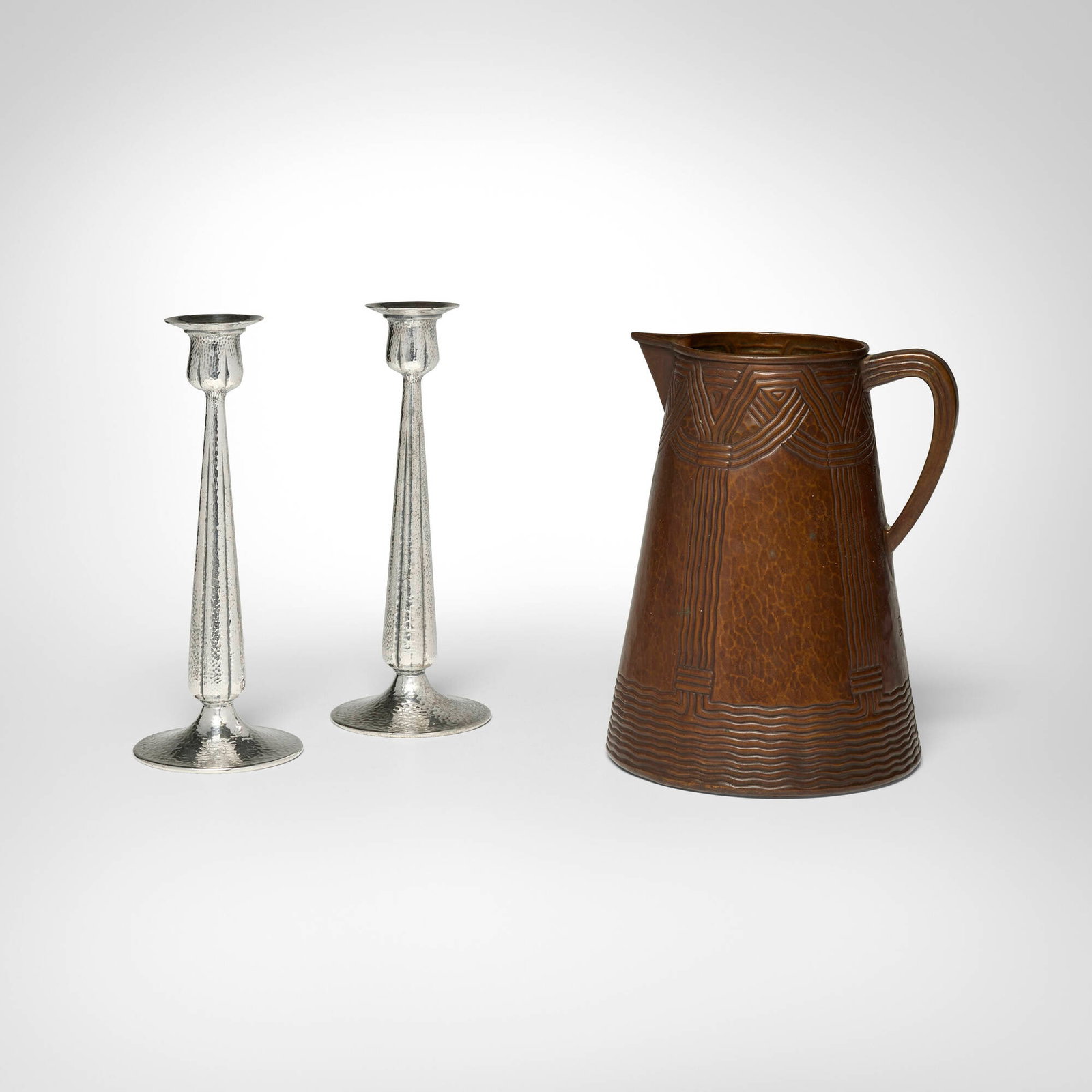 Arts & Crafts, Collection of three table articles: Arts & Crafts Collection of three table articles 20th century handwrought copper, silver-plated metal candlestick: 10.5 h x 4 dia in (27 x 10 cm) pitcher: 10 h x 7.75 dia in (25 x 20 cm) Collection
