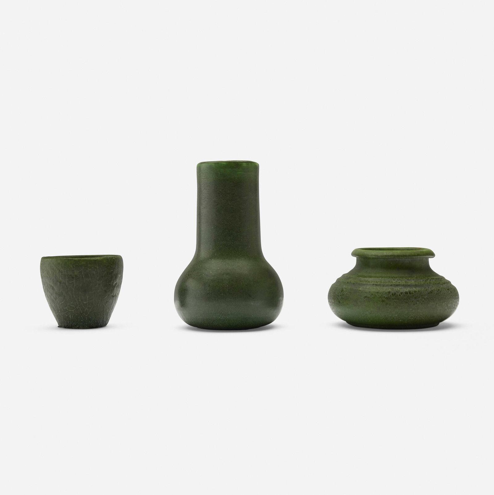 Grueby Faience Company, Collection of three vessels: Grueby Faience Company Collection of three vessels USA, 1899-1910 glazed earthenware 6.75 h x 4.375 dia in (17 x 11 cm) 3.25 h x 5.25 dia in (8 x 13 cm) 3 h x 3.5 dia in (8 x 9 cm) Impressed