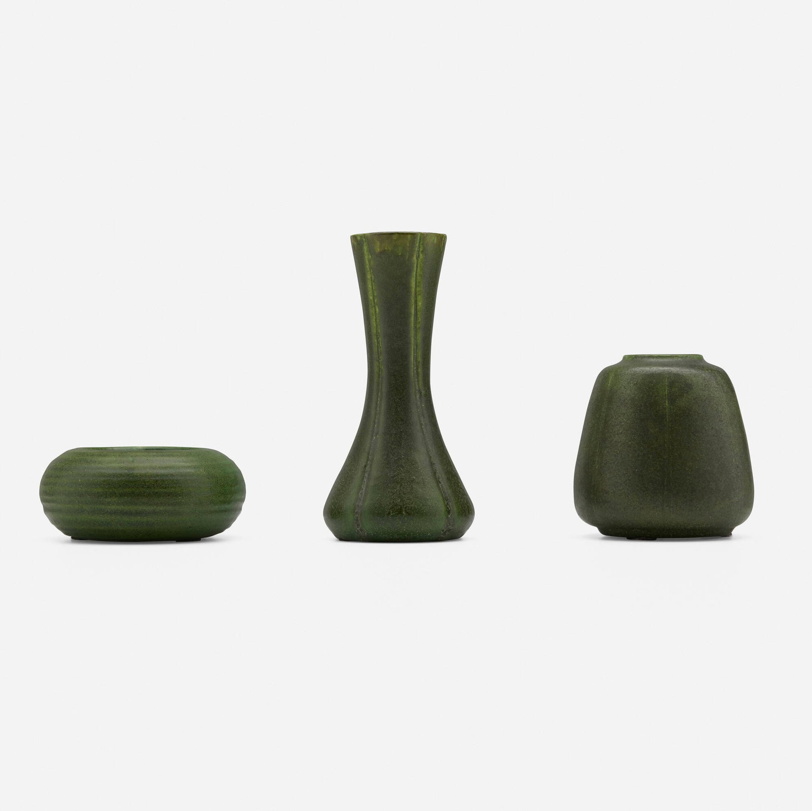 Grueby Faience Company, Collection of three vases: Grueby Faience Company Collection of three vases USA, 1898-1910 glazed earthenware 6 h x 2.75 dia in (15 x 7 cm) 3.75 h x 3.5 dia in (10 x 9 cm) 2 h x 4.25 dia in (5 x 11 cm) Collection includes one
