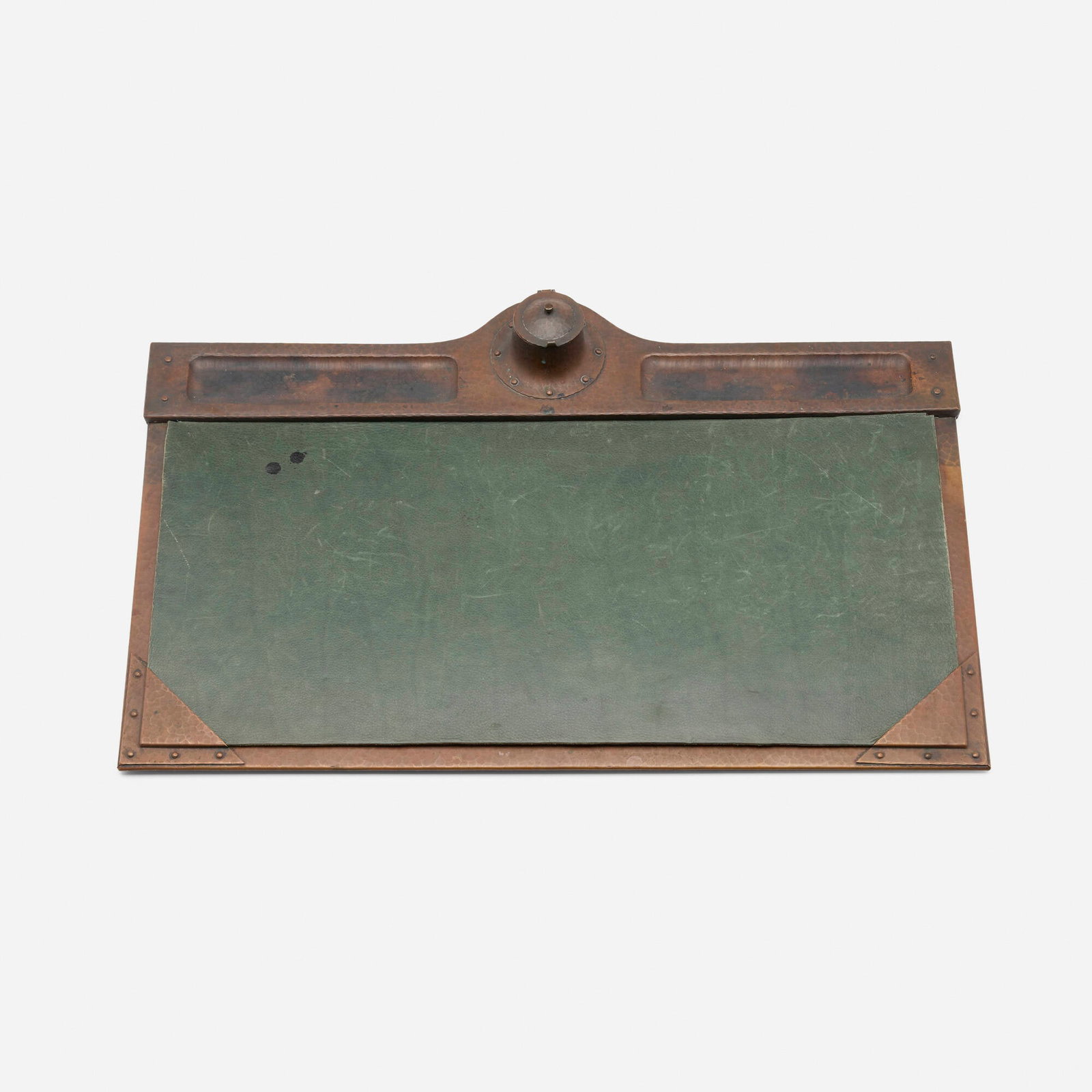 Roycroft, Desk blotter pad with inkwell: Roycroft Desk blotter pad with inkwell USA, c. 1912-15 handwrought copper, leather 2.75 h x 28 w x 18.5 d in (7 x 71 x 47 cm) Impressed orb and cross mark to upper right. This work will ship from