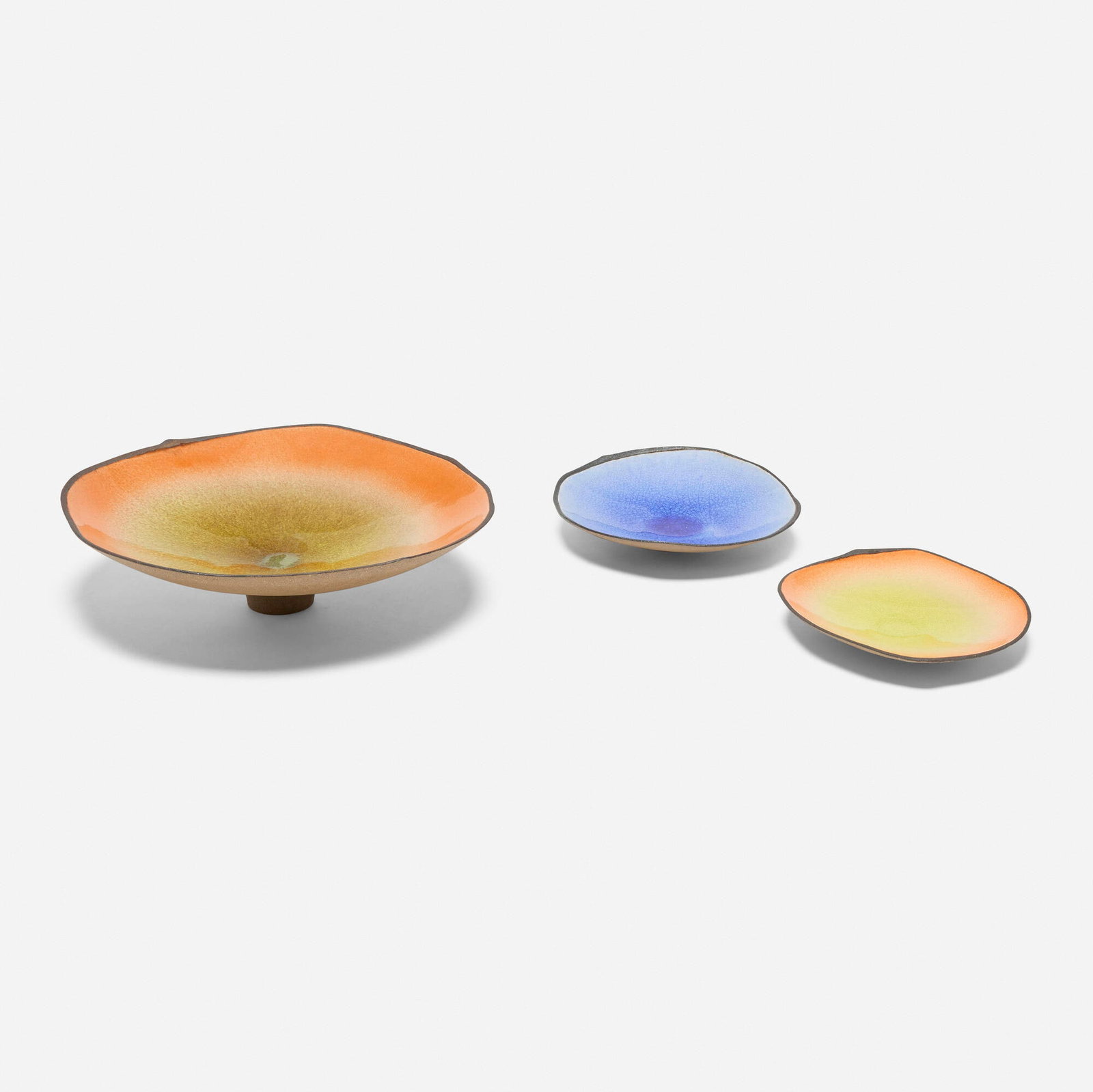 Kevin Nguyen, Collection of three centerpiece footed bowls: Kevin Nguyen Collection of three centerpiece footed bowls USA, 2008 glazed stoneware 4.5 h x 15.25 w x 15.5 d in (11 x 39 x 39 cm) 1.75 h x 9.75 w x 9.25 d in (4 x 25 x 23 cm) 1.5 h x 8.5 w x 9.