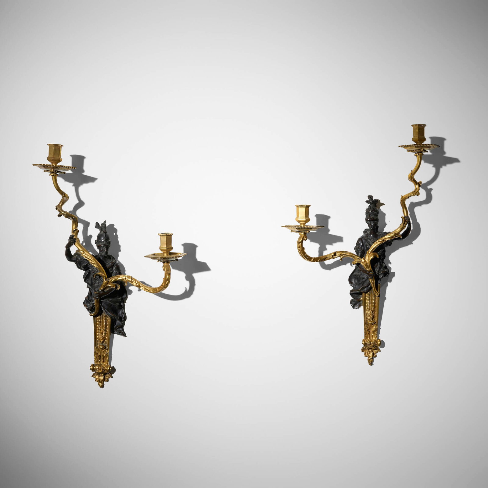 In the manner of Jean-Jacques Caffieri, Figural sconces, pair: In the manner of Jean-Jacques Caffieri Figural sconces, pair 19th century bronze, gilt bronze 23 h x 14.5 w x 6 d in (58 x 37 x 15 cm) Partial paper distributor's label to reverse of each