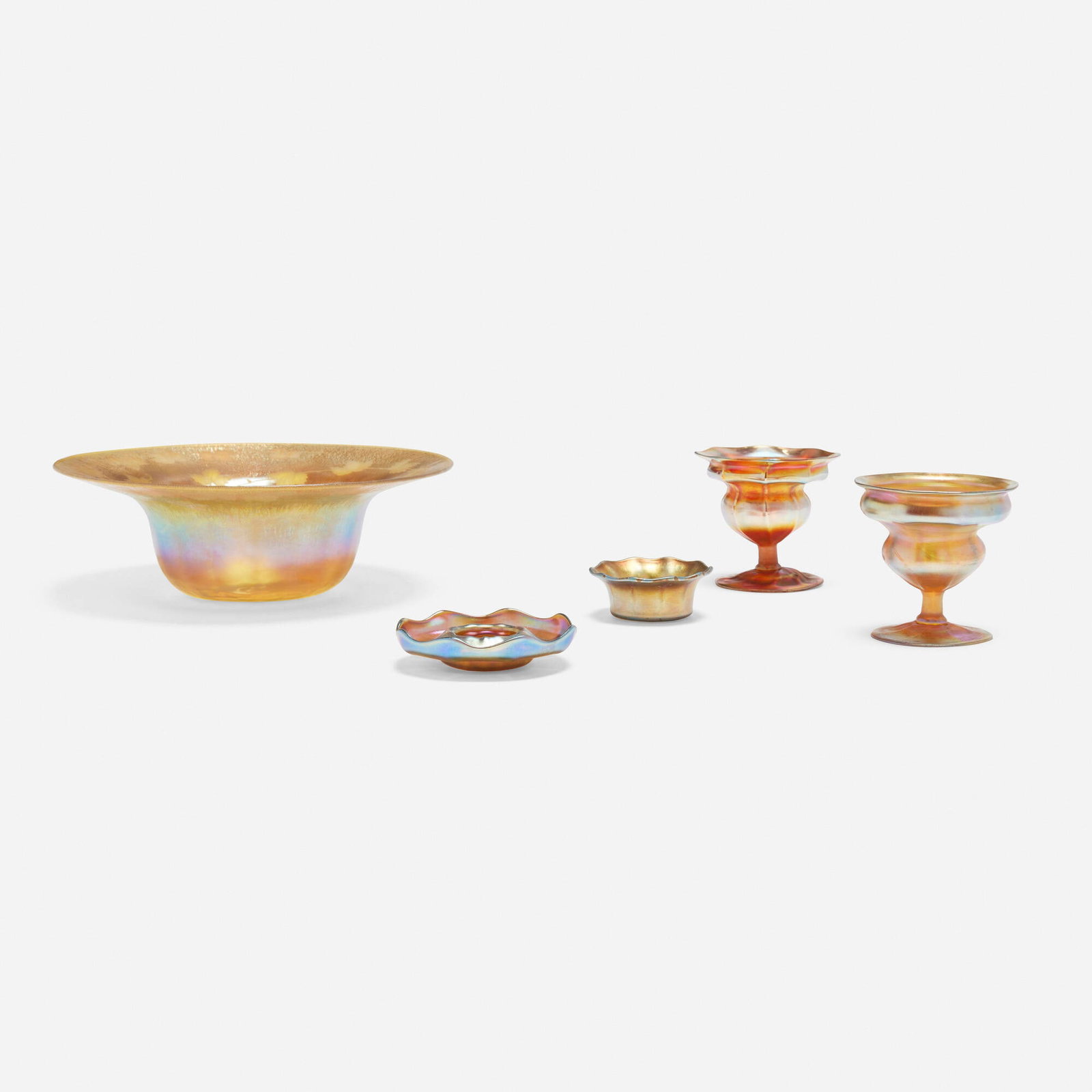 Tiffany Studios, Collection of five tablewares: Tiffany Studios Collection of five tablewares USA, c. 1905 hand-blown Favrile glass, hand-blown and wheel-carved Favrile glass largest: 3.5 h x 10.625 dia in (9 x 27 cm) smallest: 1.25 h x 3 dia in