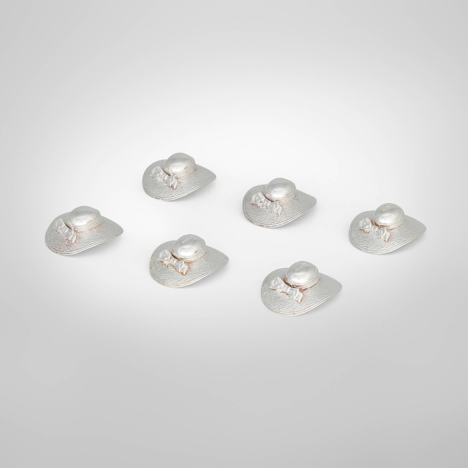 Mappin & Webb, Elizabeth II lady's hat place card holders, set of six: Mappin & Webb Elizabeth II lady's hat place card holders, set of six Sheffield, United Kingdom, 1993 silver each: 1.75 h x 0.5 w x 1.75 d in (4 x 1 x 4 cm) Impressed maker's mark 'M&W'