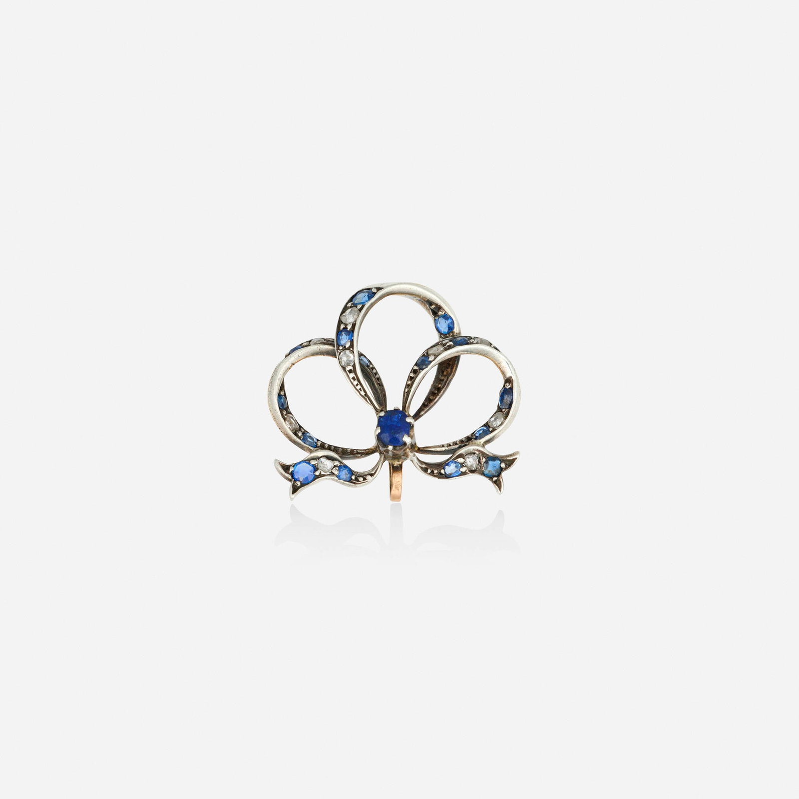 Antique, Sapphire and diamond pendant brooch: Antique Sapphire and diamond pendant brooch The bow set with oval and circular-cut sapphires and rose-cut diamonds Silver-topped pink gold 1.125 x 1 in; Gross weight 2.8 dwts This work will ship from 