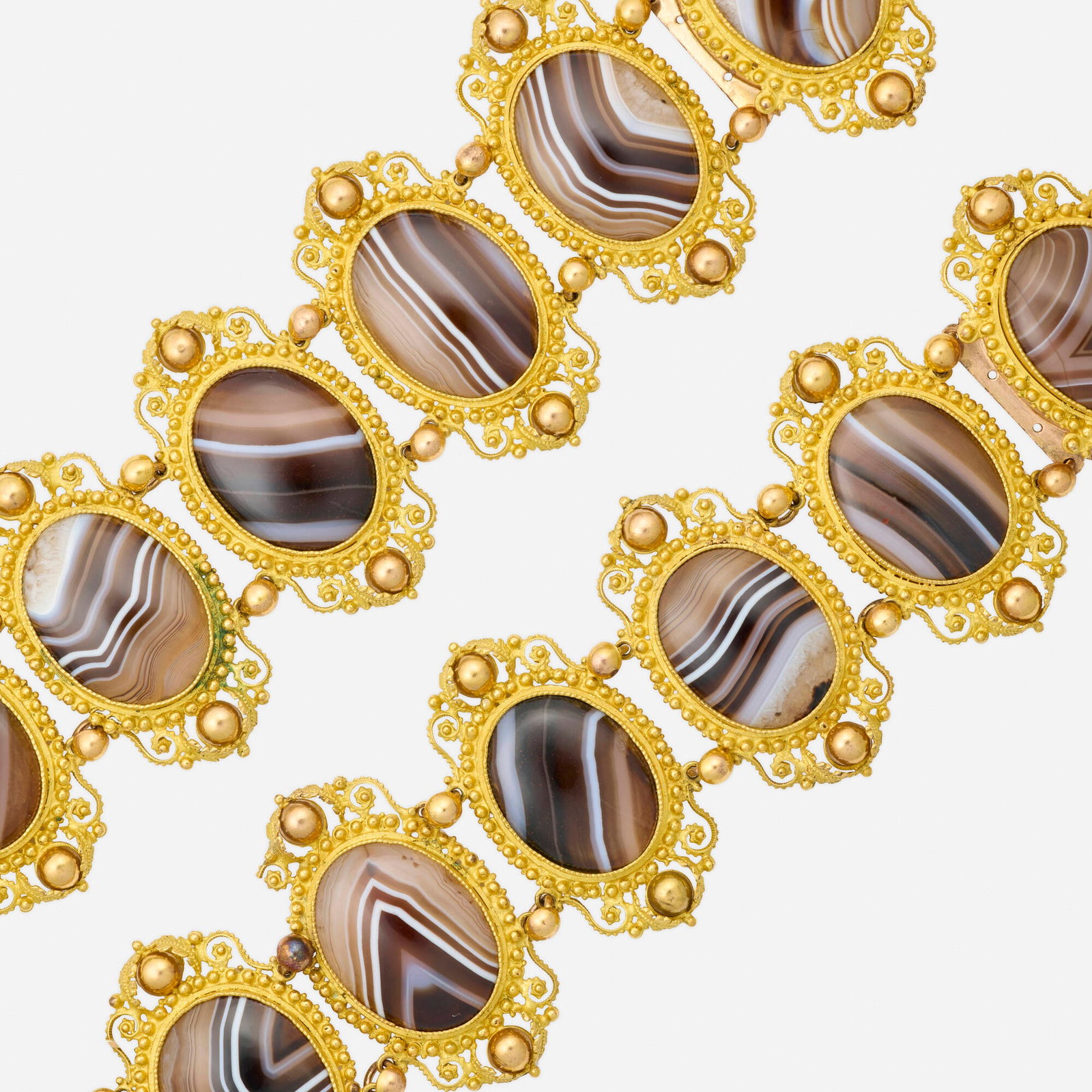Georgian, Two agate and gilt metal bracelets: Georgian Two agate and gilt metal bracelets Each of beaded ornamental design, set with cabochon banded agate Gilt metal Each 7.25 x 2 in; Gross weight 88.4 dwts This work will ship from Lambertville, 