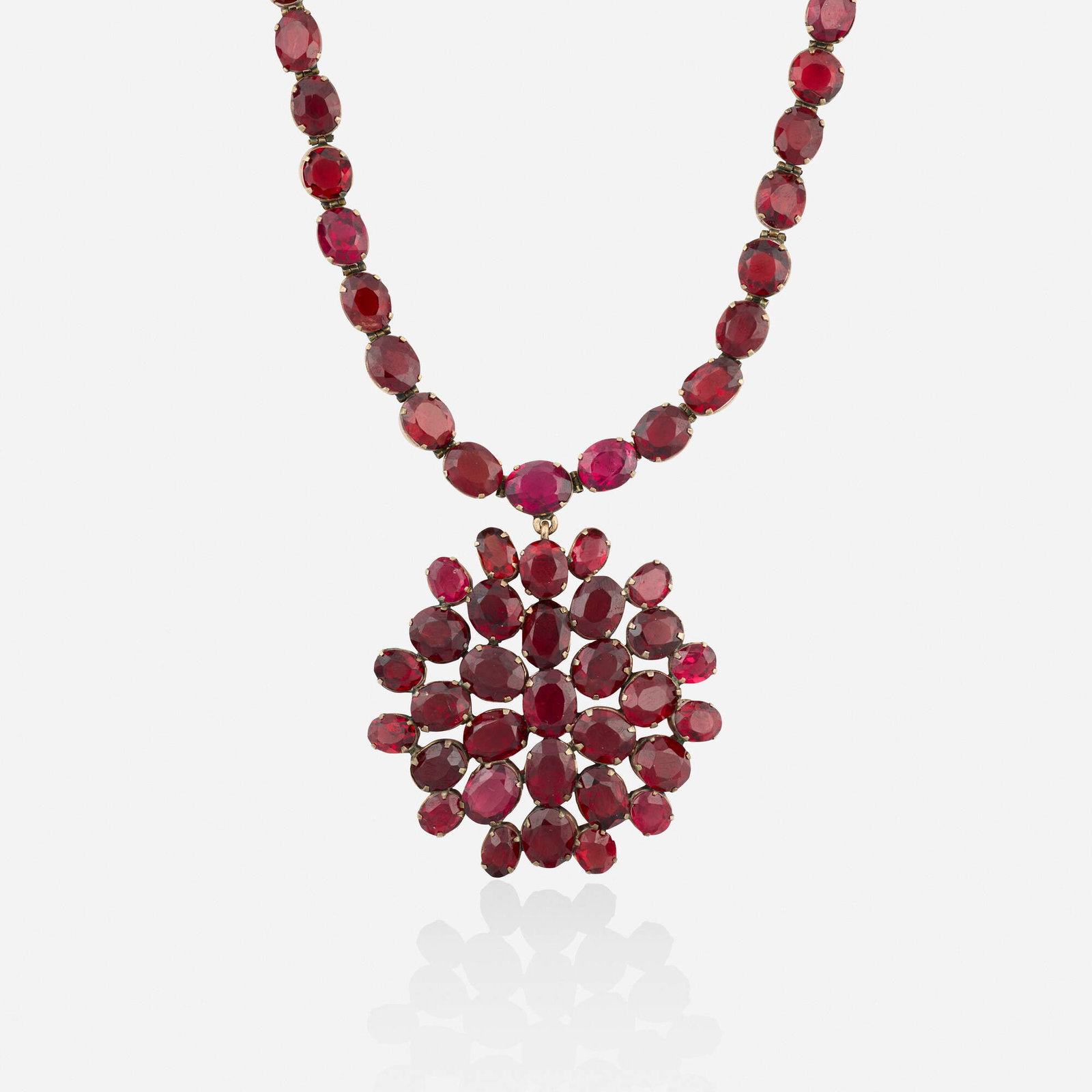 Antique, Garnet and pink gold necklace: Antique Garnet and pink gold necklace Set with oval-cut garnets Pink gold Necklace 15.75 in, pendant 2 x 1.75 in; Gross weight 23.4 dwts This work will ship from Lambertville, New Jersey.