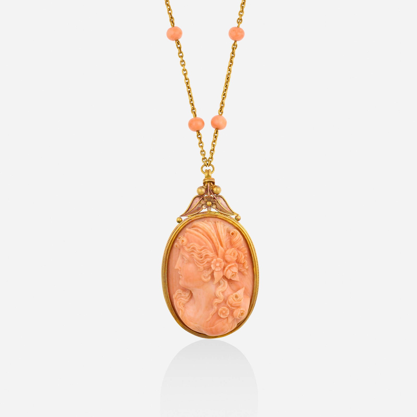 Antique, Coral and gold necklace: Antique Coral and gold necklace The pendant brooch set with a carved coral cameo of a female profile, suspended from the fine-link chain with coral beads Yellow gold Necklace 19 in, pendant brooch