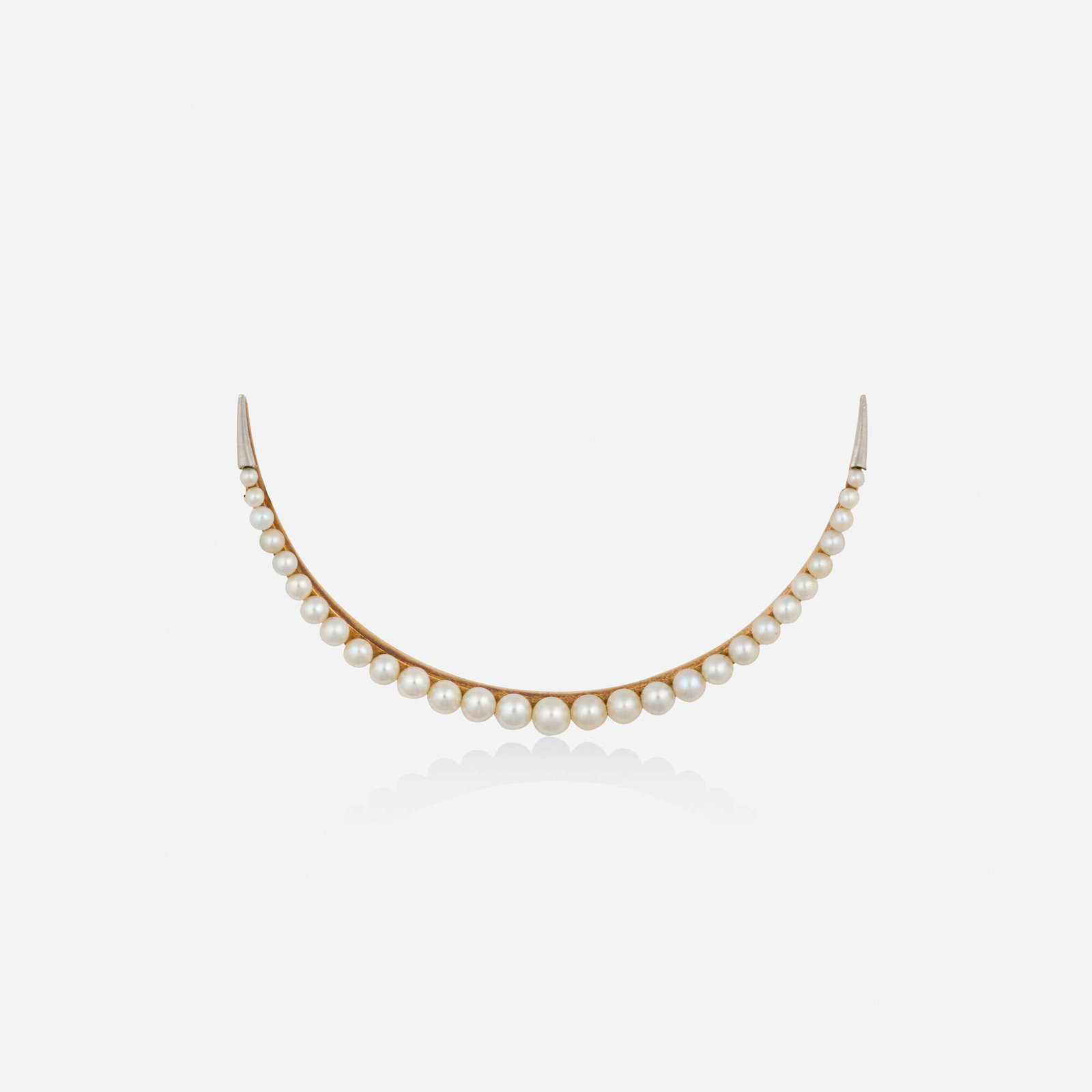 Antique, Seed pearl and gold brooch: Antique Seed pearl and gold brooch The crescent moon set with graduated seed pearls Platinum-topped yellow gold 2.25 x 1.25 in; Gross weight 3.2 dwts This work will ship from Lambertville, New Jersey.