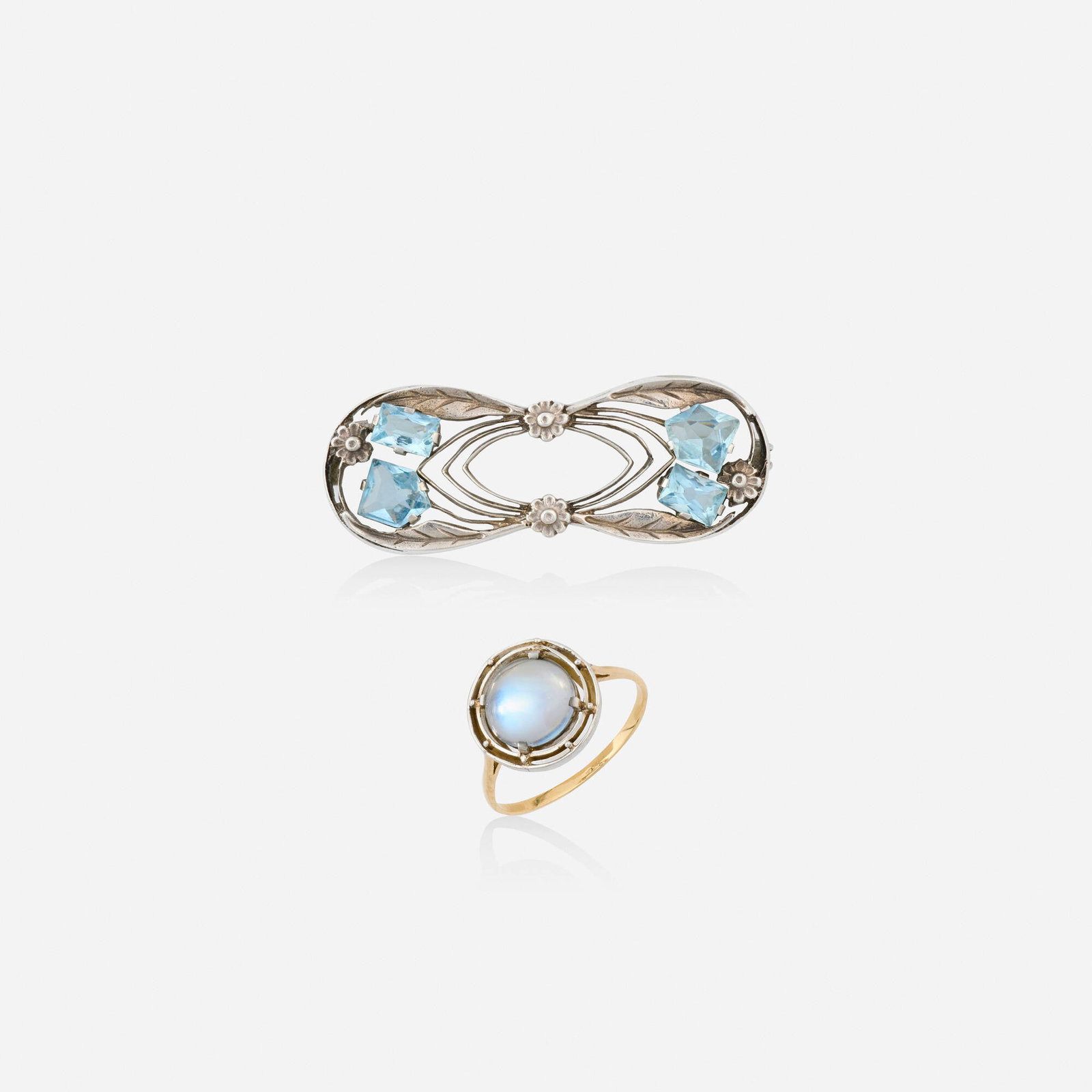 Liberty & Co., attribution, Arts & Crafts aquamarine brooch and moonstone ring: Liberty & Co., attribution Arts & Crafts aquamarine brooch and moonstone ring Comprising a floral brooch set with fancy-cut aquamarines; and a ring set with a cabochon moonstone Silver, platinum-toppe
