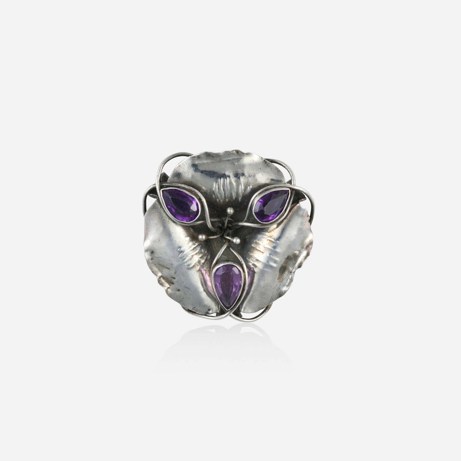 Charles Robert Ashbee for Guild of Handicraft, Rare Arts & Crafts amethyst and silver pendant brooch: Charles Robert Ashbee for Guild of Handicraft Rare Arts & Crafts amethyst and silver pendant brooch Of floral design, set with pear-shaped amethysts Silver 1.625 x 1.625 in; Gross weight 8.5 dwts Prov