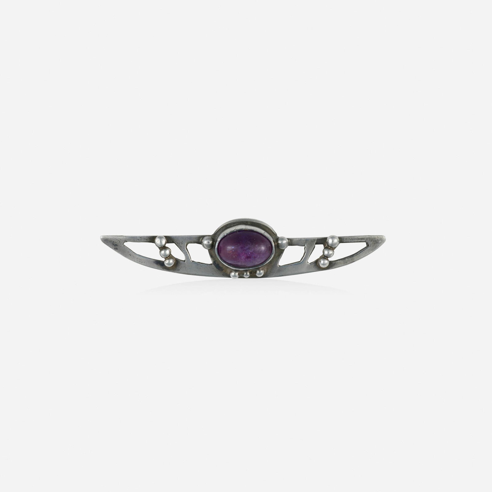Rosalie Roos Wiener for Newcomb College Pottery, Arts & Crafts amethyst and silver brooch: Rosalie Roos Wiener for Newcomb College Pottery Arts & Crafts amethyst and silver brooch Set with a cabochon amethyst Silver 2.375 x 0.50 in; Gross weight 3.9 dwts Sold with certificate of authenticit