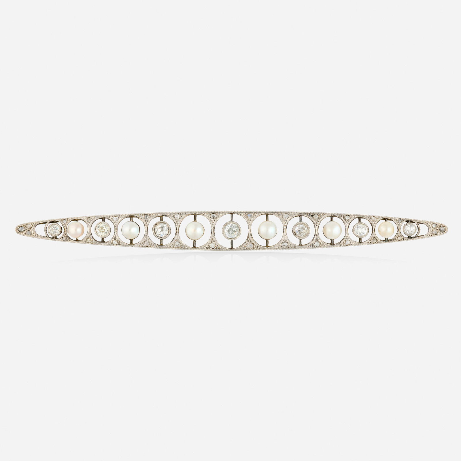 Edwardian, Diamond, pearl, and platinum brooch: Edwardian Diamond, pearl, and platinum brooch Set with pearls, and old mine and rose-cut diamonds Platinum 4.50 x 0.375 in; Gross weight 7.0 dwts This work will ship from Lambertville, New Jersey.