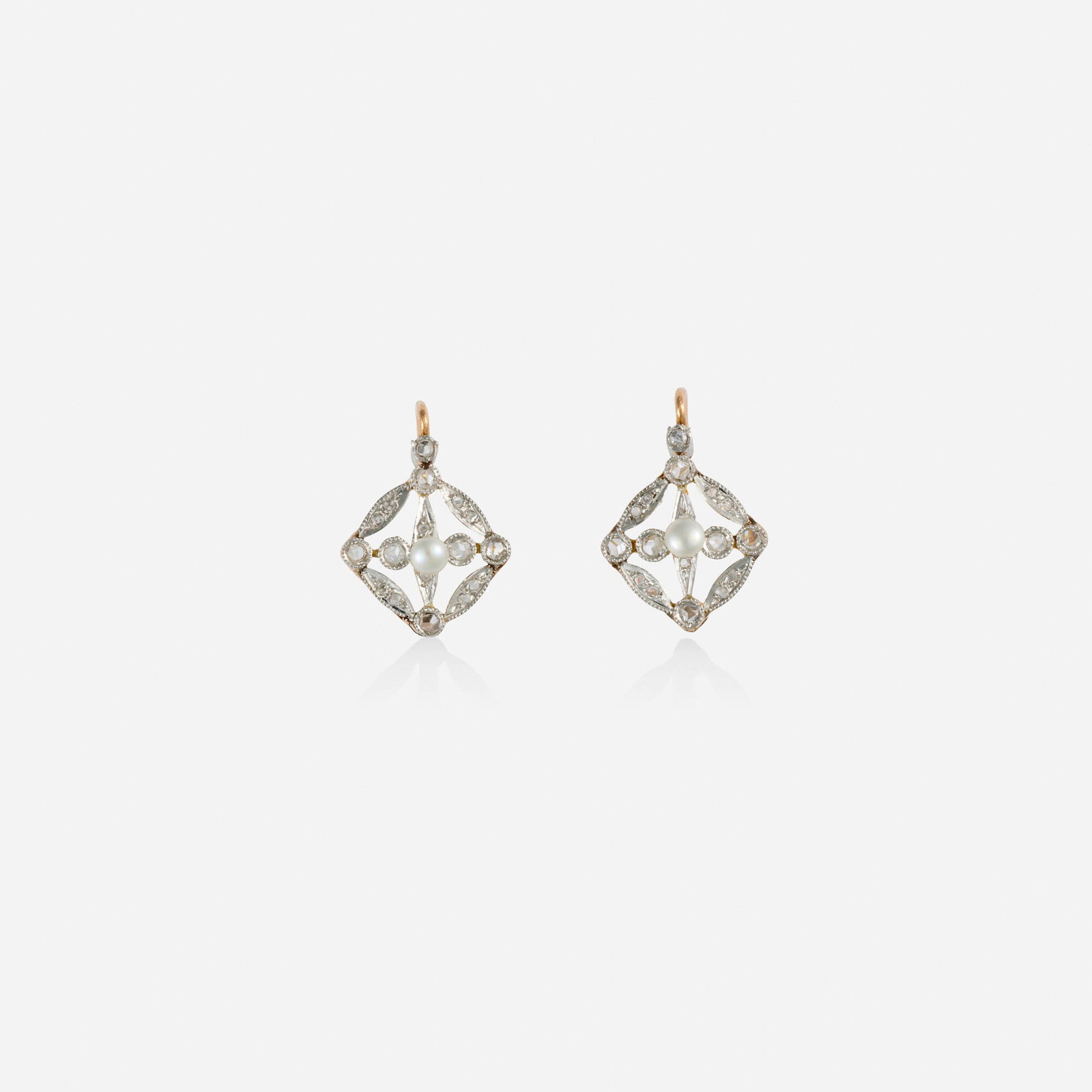 Edwardian, Diamond and seed pearl earrings: Edwardian Diamond and seed pearl earrings Each set with a seed pearl and rose-cut diamonds Platinum-topped 18k yellow gold 0.625 x 0.50 in; Gross weight 1.9 dwts Sold with fitted box This work will sh