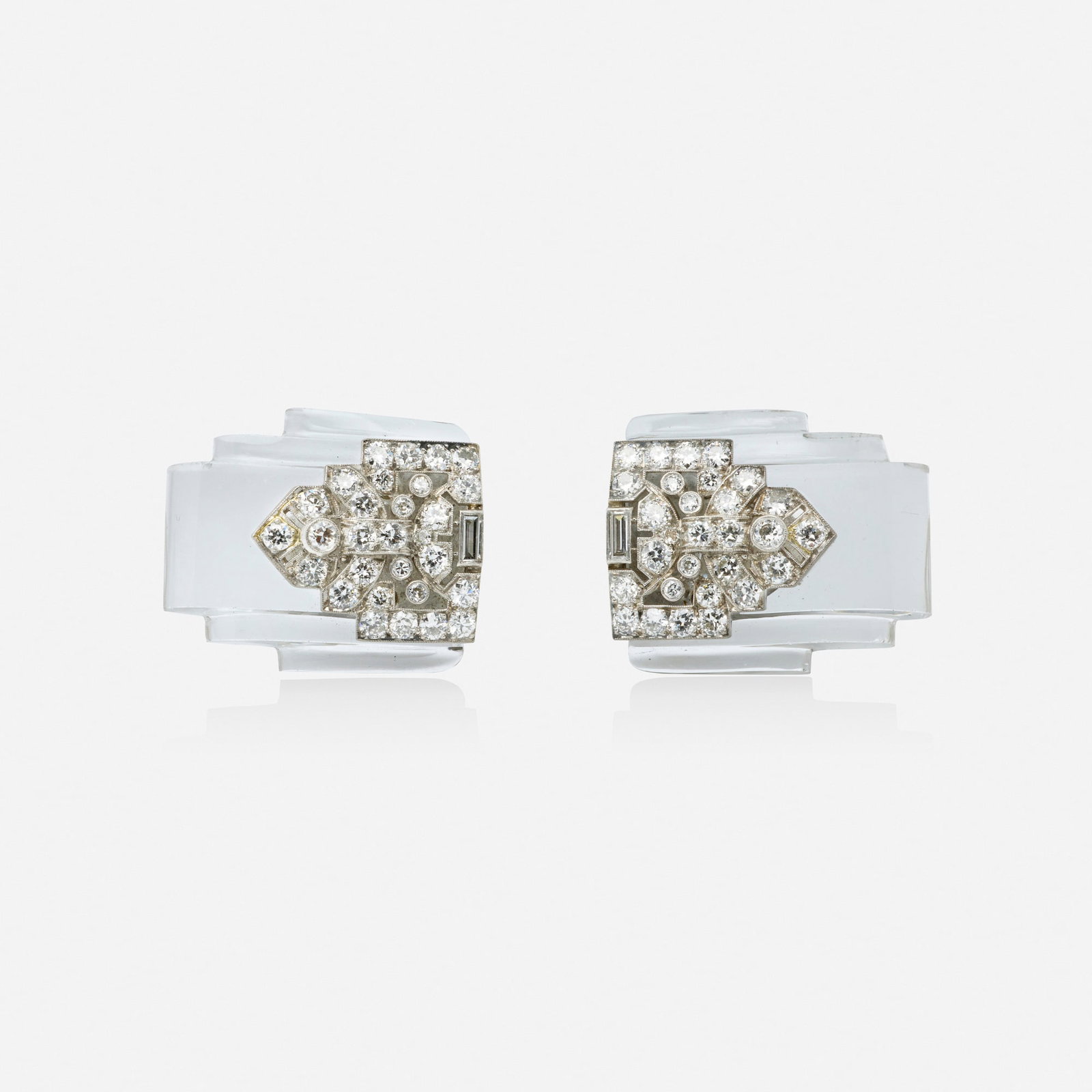 Art Deco, Two diamond and rock crystal dress clips: Art Deco Two diamond and rock crystal dress clips Each of geometric design, set with old European and baguette-cut diamonds Platinum, white gold Each 1.125 x 0.875 in; Gross weight 17.7 dwts This work
