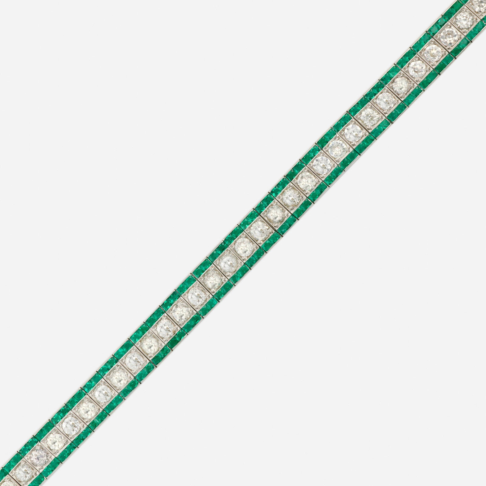 Art Deco, Emerald and diamond bracelet: Art Deco Emerald and diamond bracelet The line bracelet set with old European-cut diamonds and French-cut emeralds Platinum, pink gold 7.50 x 0.375 in; Gross weight 19.7 dwts This work will ship from 