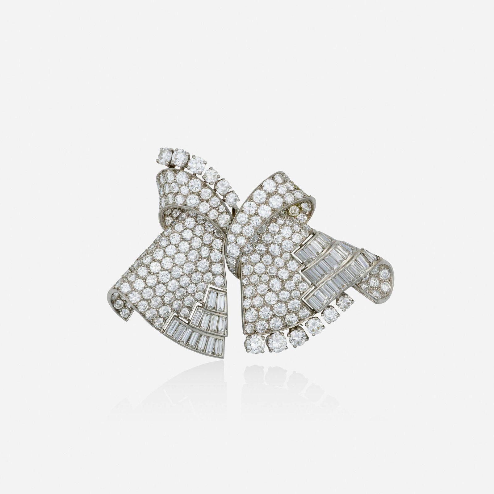 Art Deco, Diamond and platinum double clip brooch: Art Deco Diamond and platinum double clip brooch Of scrolling design, set with round brilliant and single-cut diamonds; may be worn connected as one brooch or separately as two Platinum Connected 2.50