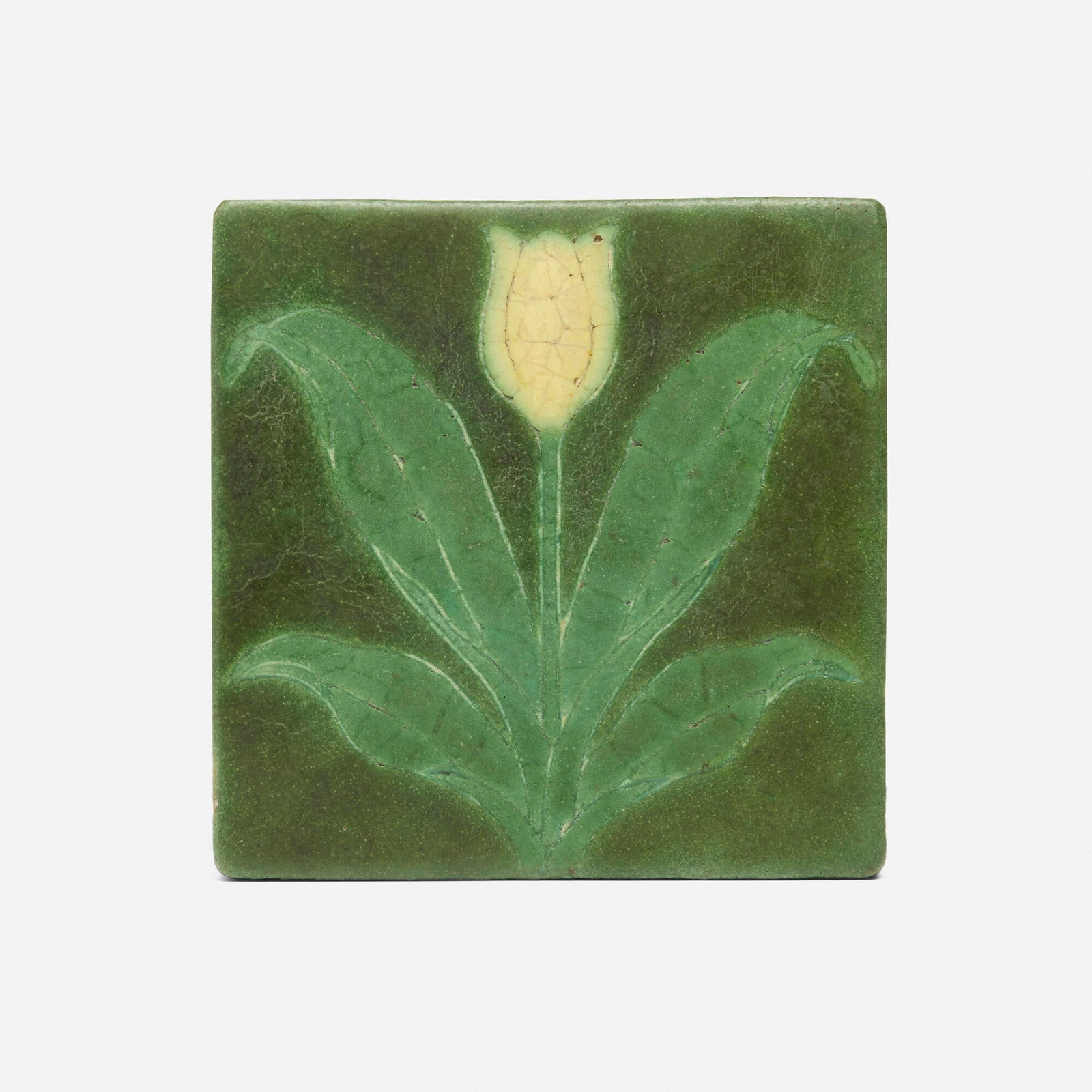 George P. Kendrick for Grueby Faience Company, Trivet tile with yellow tulip: George P. Kendrick for Grueby Faience Company Trivet tile with yellow tulip USA, 1901 glazed earthenware decorated in cuenca 6 h x 6 w x 1 d in (15 x 15 x 3 cm) Original paper label to edge