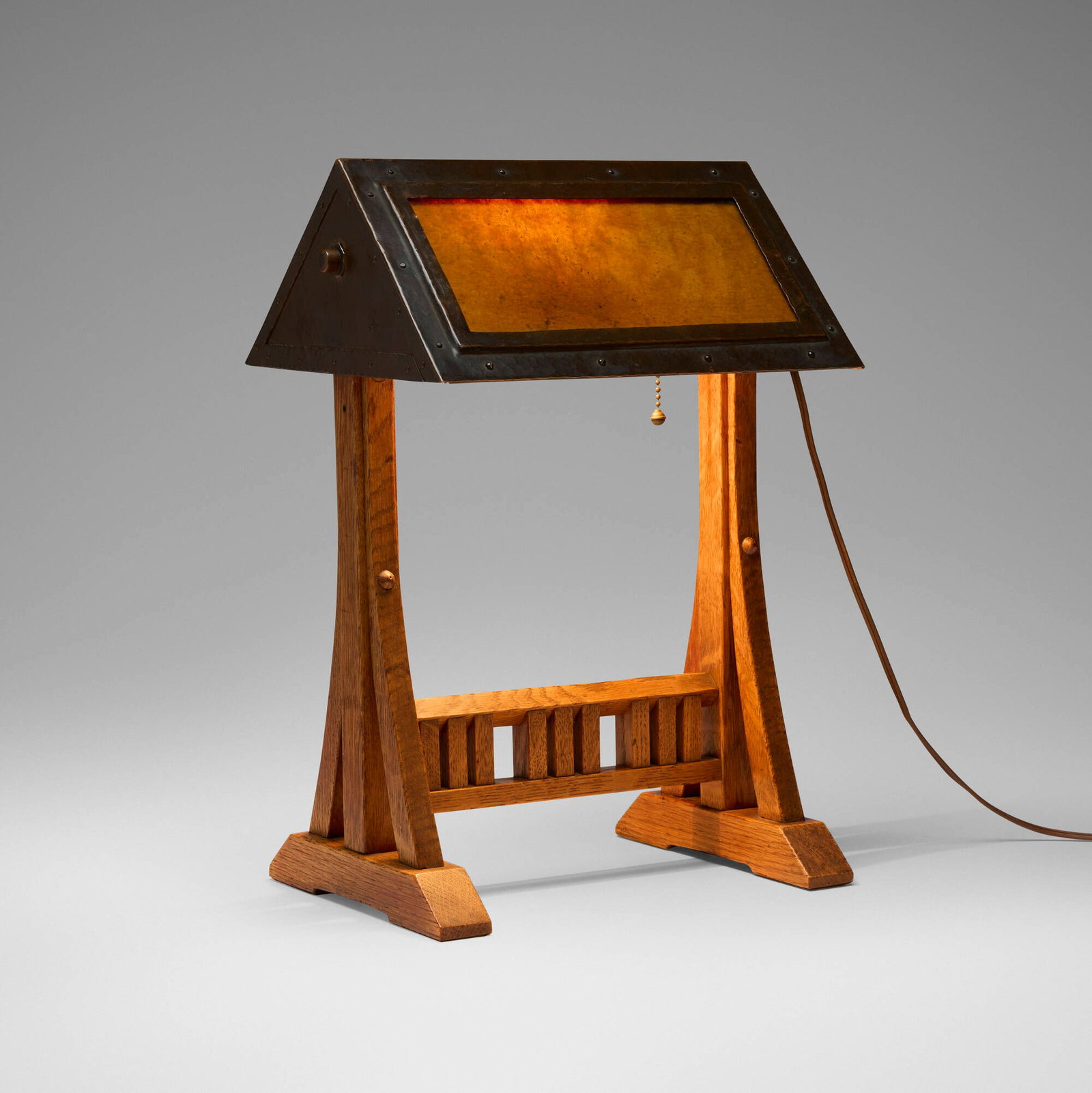 Gustav Stickley, Rare desk lamp, model 506: Gustav Stickley Rare desk lamp, model 506 USA, c. 1906 oak, brass, glass with laminated parchment 16 h x 11 w x 9 d in (41 x 28 x 23 cm) Impressed manufacturer's mark to side of shade 'Als ik kan'