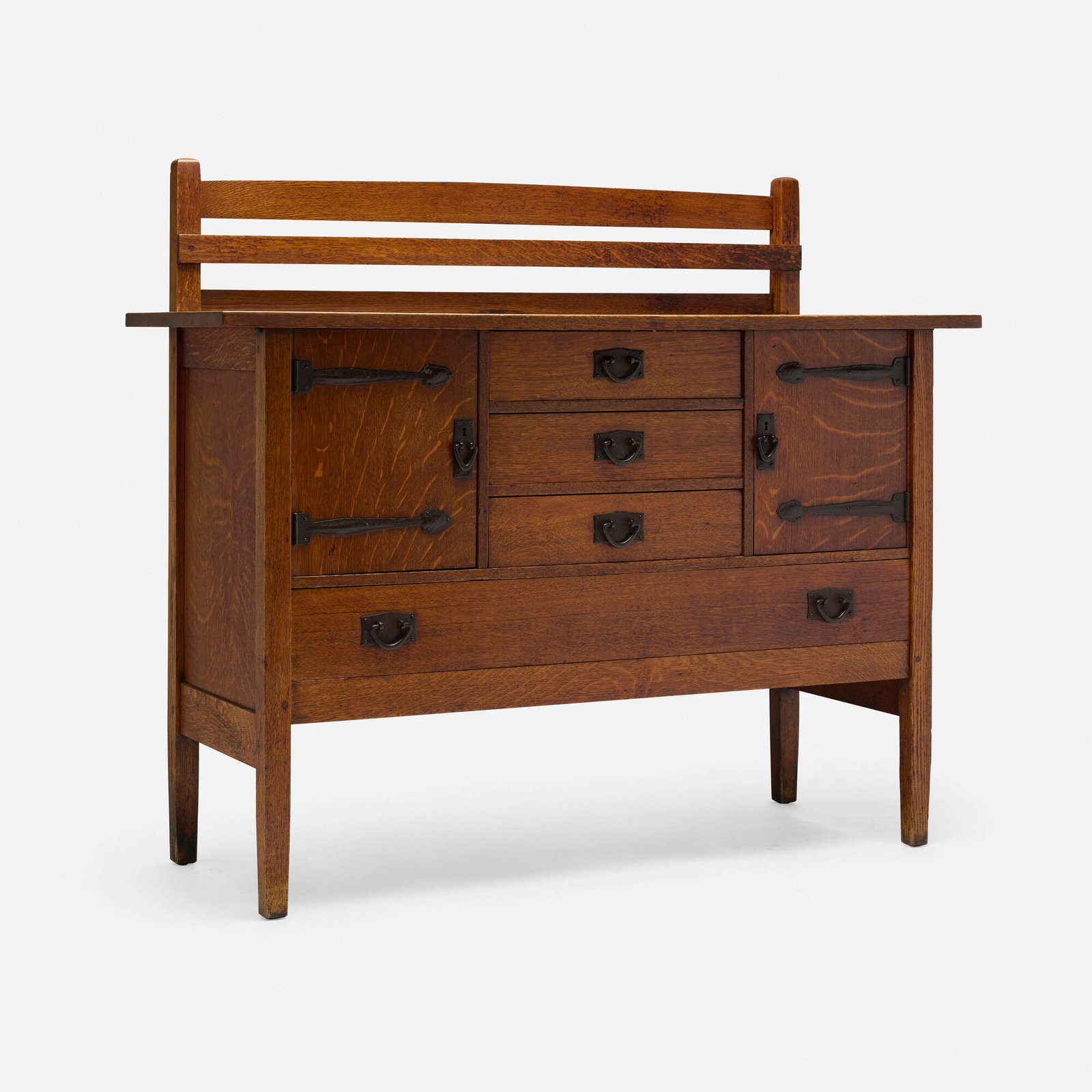 Gustav Stickley, Sideboard, model 814 1/2: Gustav Stickley Sideboard, model 814 1/2 USA, c. 1912-16 oak, iron 49 h x 56 w x 21 d in (124 x 142 x 53 cm) Sideboard features four drawers and two doors concealing storage. Branded