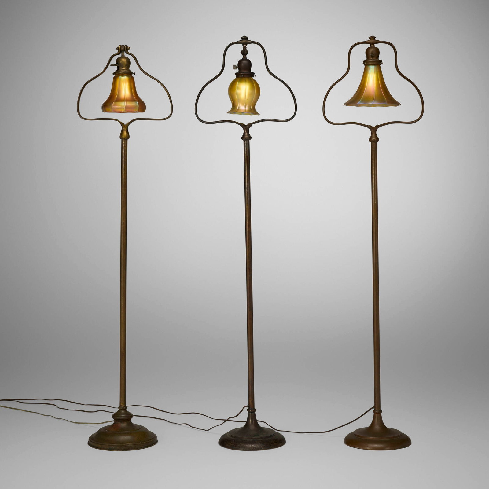 Handel, Collection of three floor lamps: Handel Collection of three floor lamps USA, c. 1915 bronzed metal, patinated brass, hand-blown glass, hand-blown Aurene glass 56.5 h x 14 w x 9.25 d in (144 x 36 x 23 cm) 56 h x 13.75 w x 9.25 d in (1