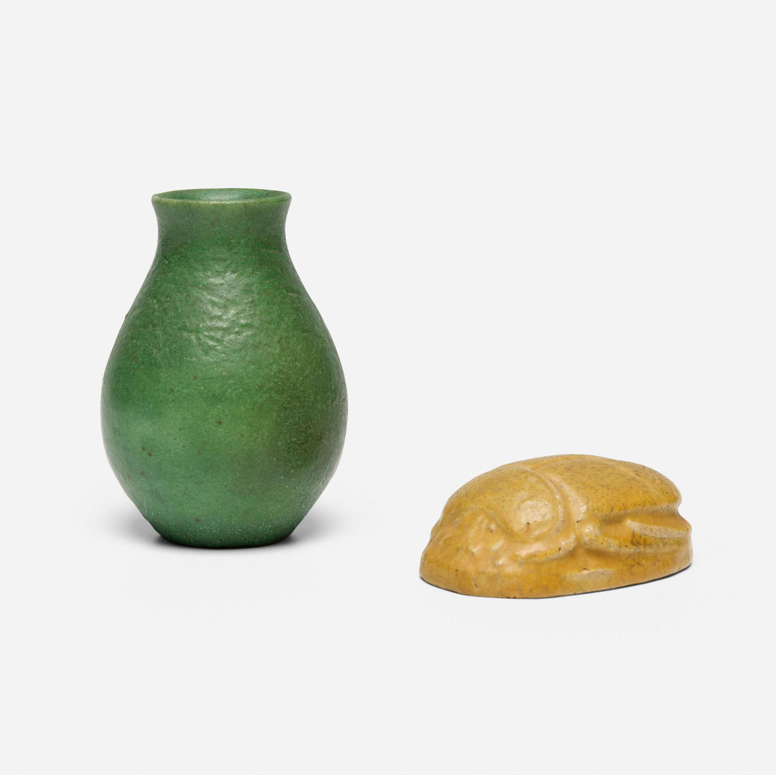 Grueby Faience Company, Vase and scarab paperweight: Grueby Faience Company Vase and scarab paperweight USA, 1899-1910 glazed earthenware 4.75 h x 3.25 dia in (12 x 8 cm) 1.25 h x 3.75 w x 2.5 d in (3 x 10 x 6 cm) Impressed manufacturer's mark to