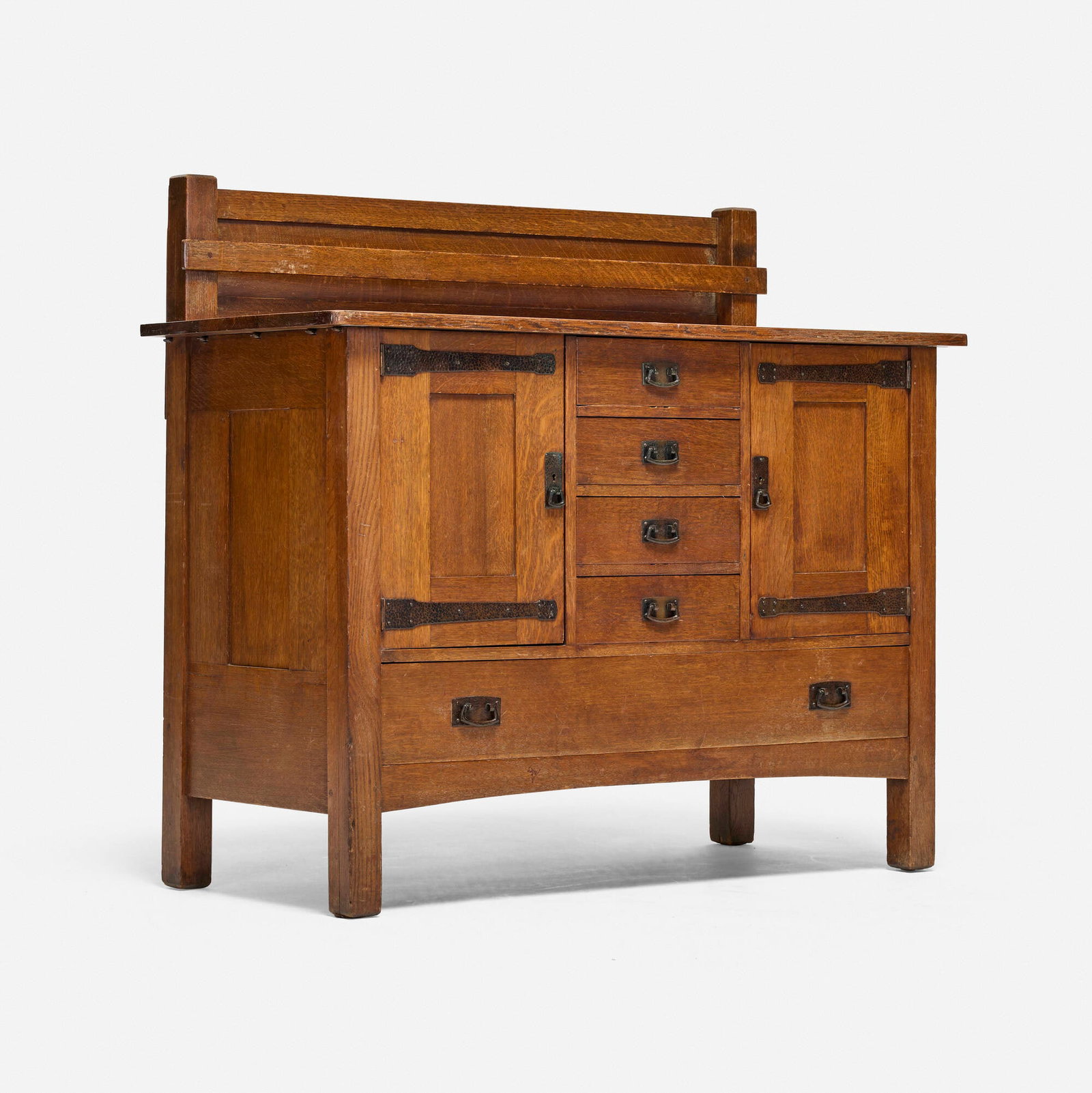 L. & J.G. Stickley, Sideboard, model 745 variant: L. & J.G. Stickley Sideboard, model 745 variant USA, c. 1910 oak, bronze 48.25 h x 54 w x 24.5 d in (123 x 137 x 62 cm) Sideboard features five drawers and two doors concealing storage compartments.