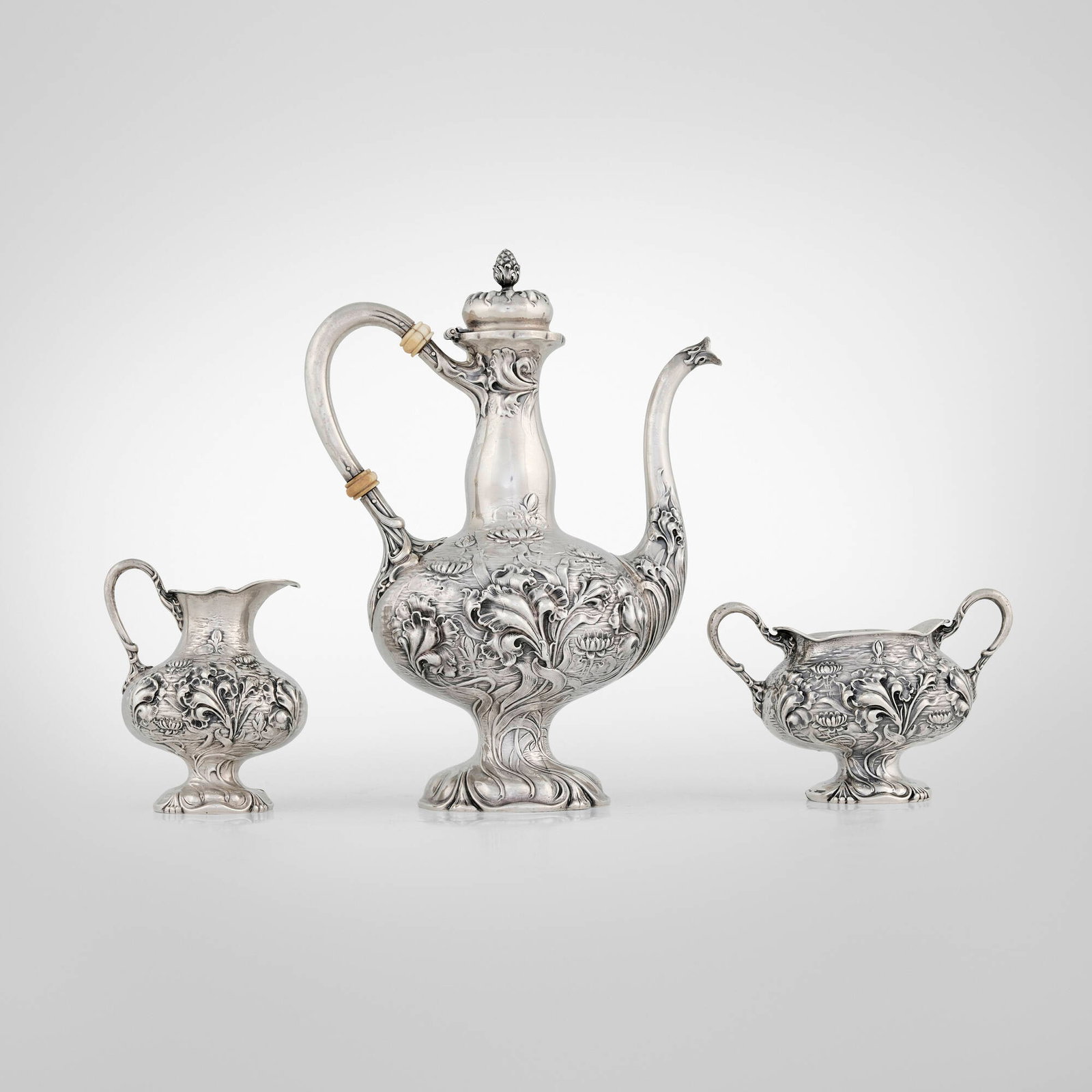 Unger Brothers, Art Nouveau three-piece coffee service with flowers: Unger Brothers Art Nouveau three-piece coffee service with flowers Newark, USA, c. 1900 sterling silver, bone coffee pot: 9 h x 6.75 w x 3.75 d in (23 x 17 x 10 cm) creamer: 4 h x 3 w x 2.75 d in (10 