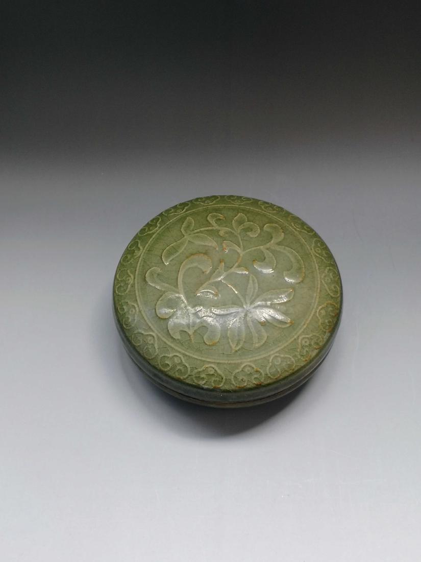 China, Yao Zhou Yao Depiction Rouge Box: There are delicate flower picture carved in the cover of the box.The body of the box is oval-shaped. The whole body is covered with white glaze. H:1.5in D:4.3in