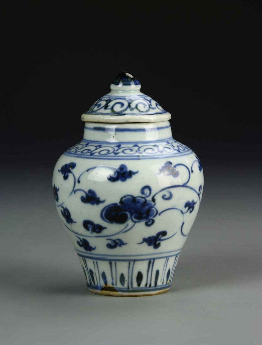 Chinese Blue and White Jar: China, Ming period, blue and white jar, wide shoulders, tapering sides to flat base, with fitted lid, painted blue borders and floral designs throughout against white ground. Height 5 in.