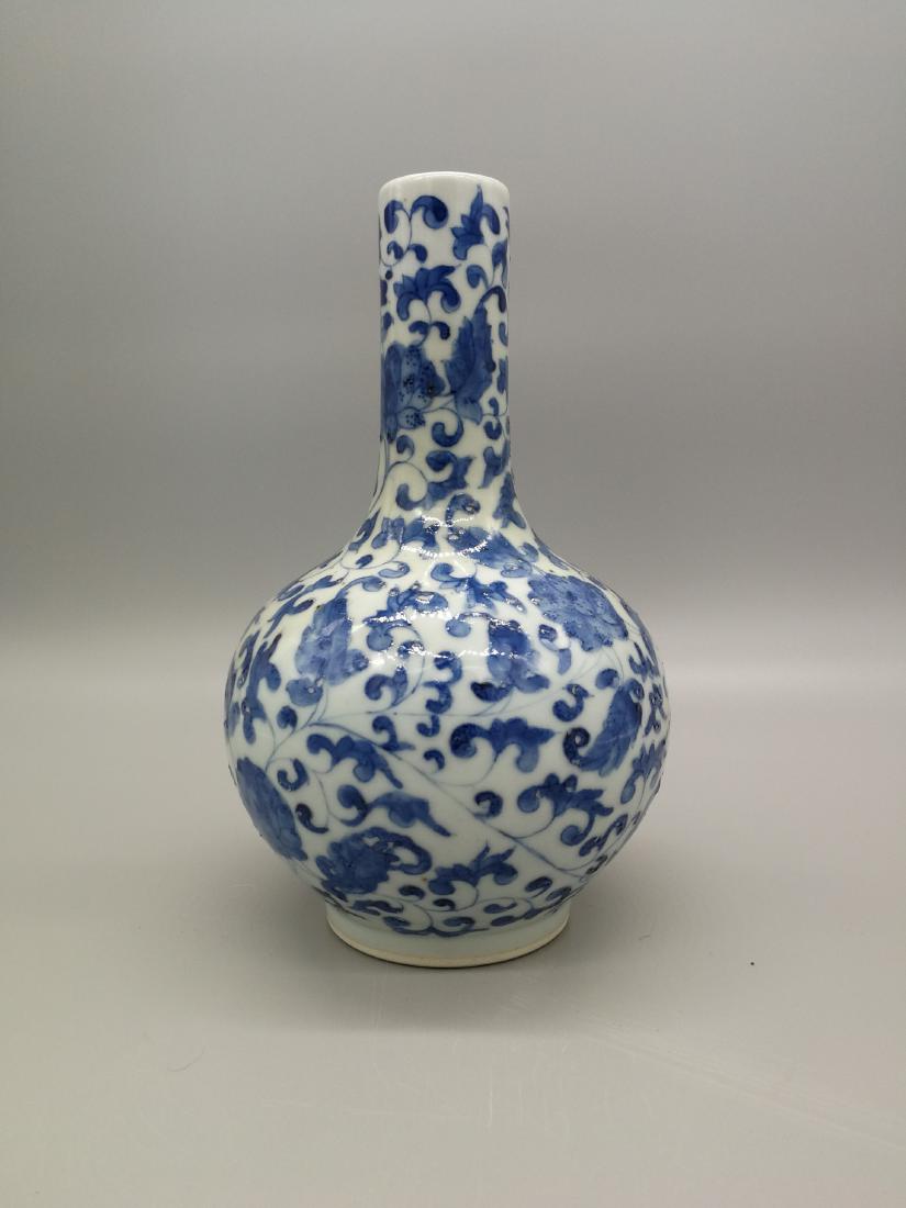 China, Blue and white Tian Qiu Vase: The bottle has a straight mouth, a long neck, a flat round belly and a round foot.The whole body is covered with Blue and white glaze . There are arabesquitic patterns curved on the outer of the vase.
