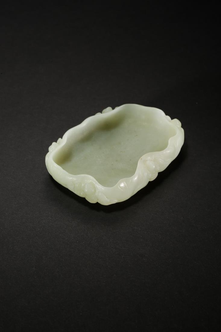 A JADE CARVING 'BAT ON LOTUS LEAF' BRUSH WASHER: A jade carving 'bat on lotus leaf' brush washer . Probably made in the Chinese Mid Qing Dynasty Period. Dimensions: H 2.3 cm, W 9.3 cm, D 6.5 cm. Weight: 100.9 g. All measurements are approximate.