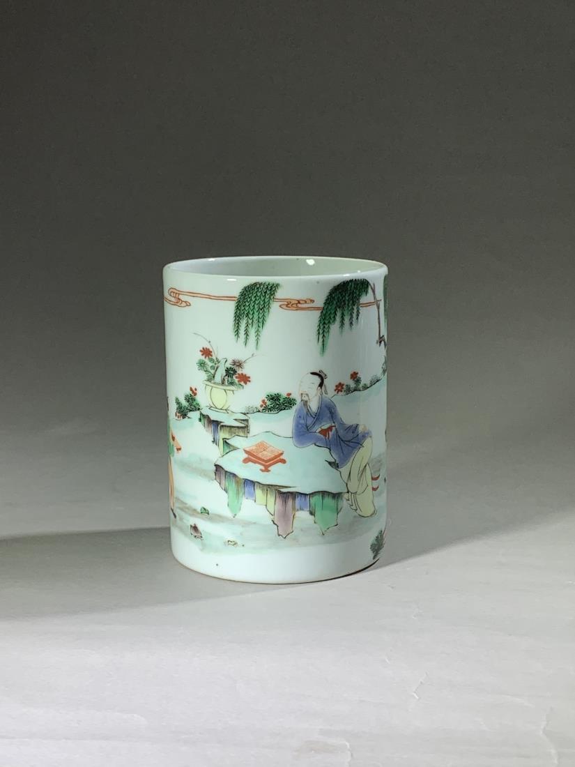 A WUCAI 'SCHOLAR IN GARDEN' PORCELAIN BRUSH POT: A wucai 'scholar in garden' porcelain brush pot. Probably made in the Chinese Late Qing Dynasty Period. Dimensions: H 13 cm, Diam 7 cm. All measurements are approximate.